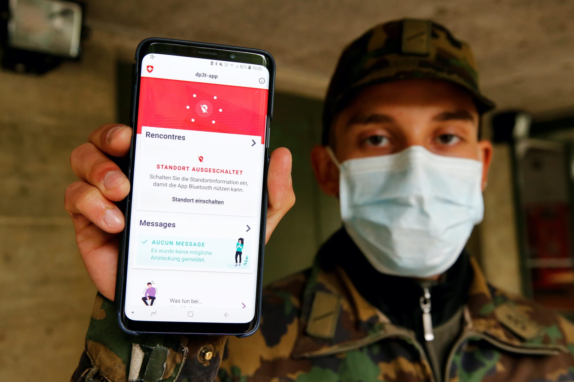 <p>A Swiss soldier shows on a mobile device the contact tracking application created by the Swiss Federal Institute of Technology Lausanne on April 30, 2020.</p>
