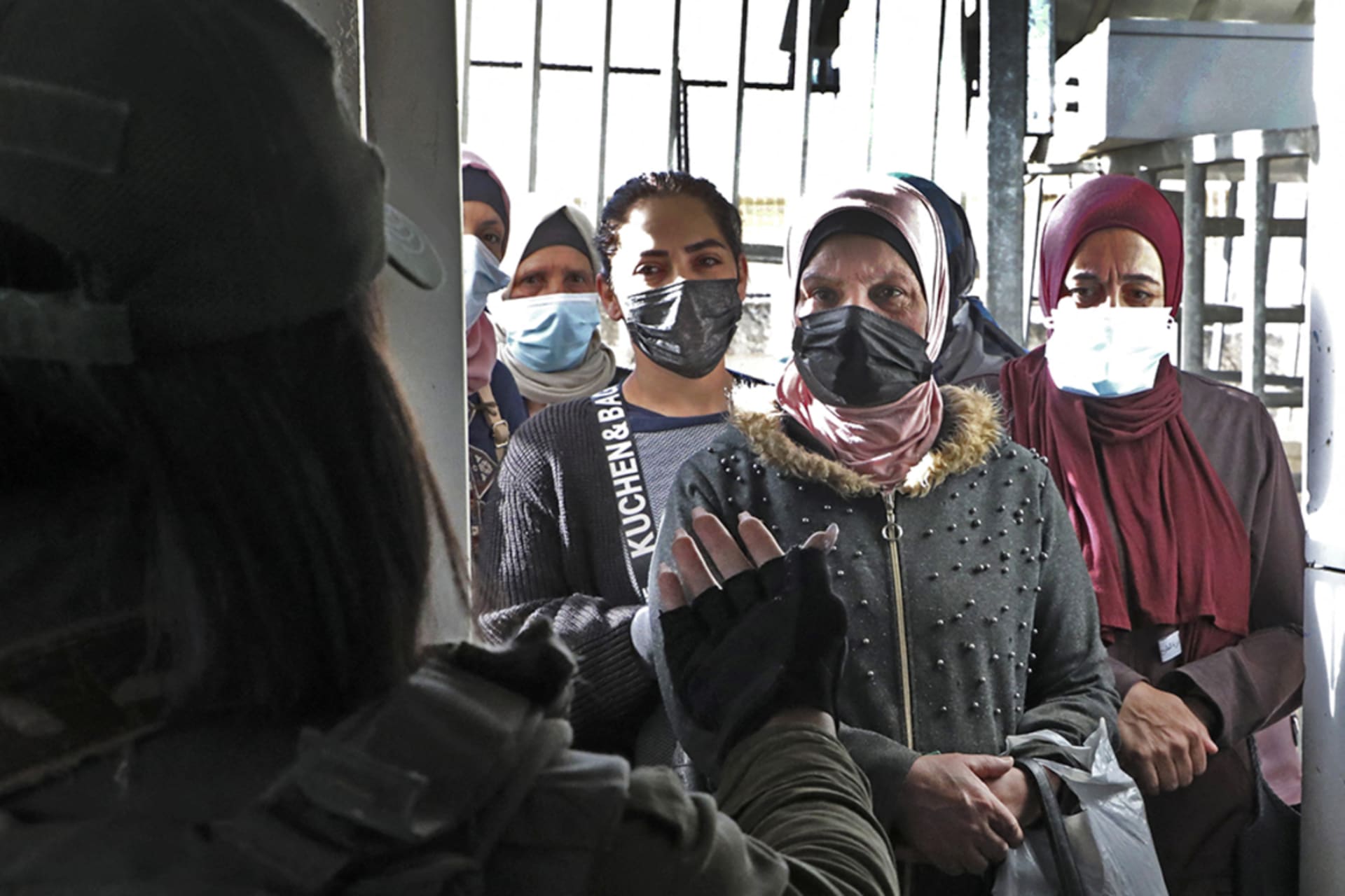 <p>Palestinians wait to enter Jerusalem to attend the first Friday prayers of the Muslim holy month of Ramadan at al-Aqsa Mosque.</p>
