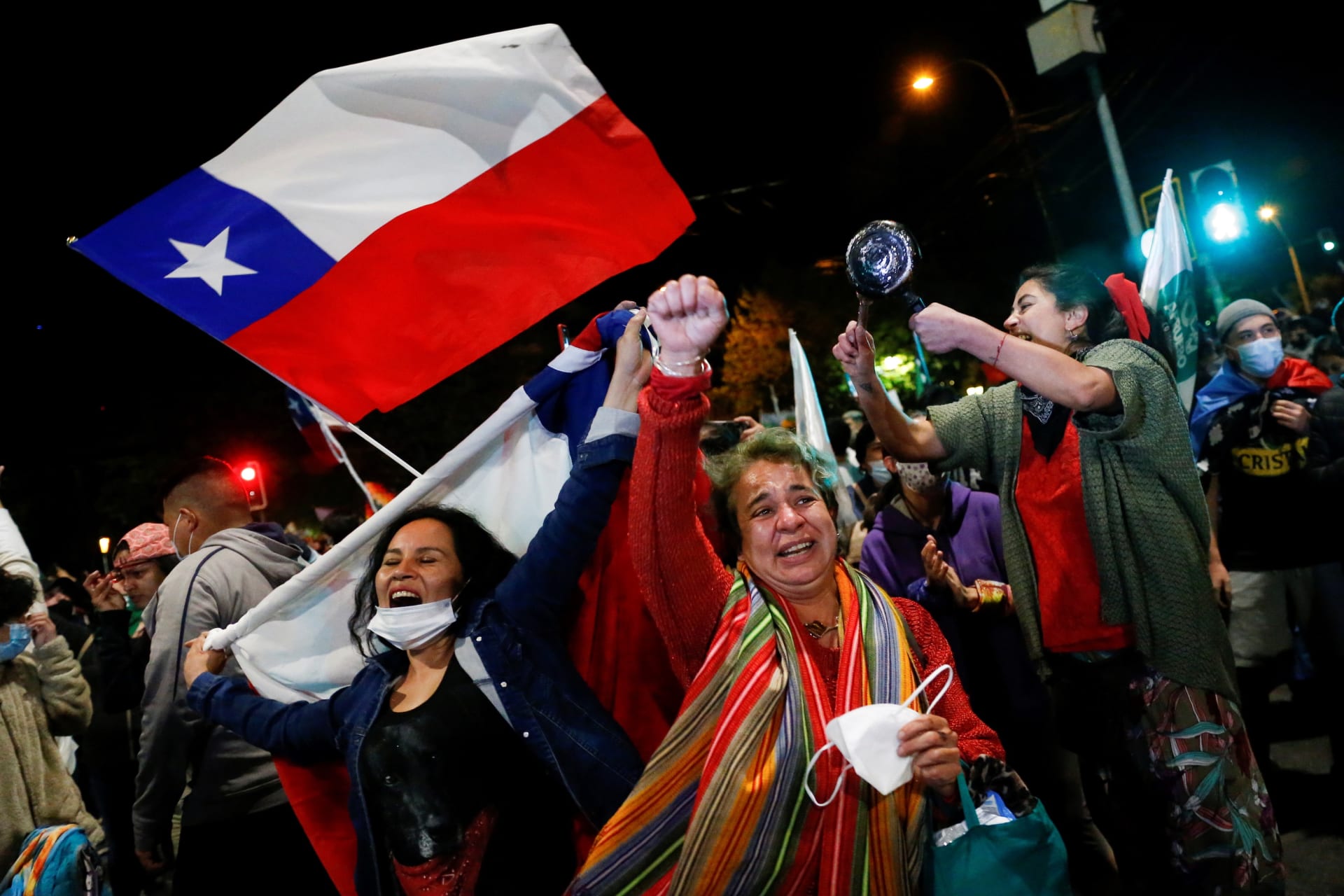 <p>Women in Valaparaiso, Chile celebrate the approval of a national referendum authorizing a rewrite of the nation’s constitution.</p>
