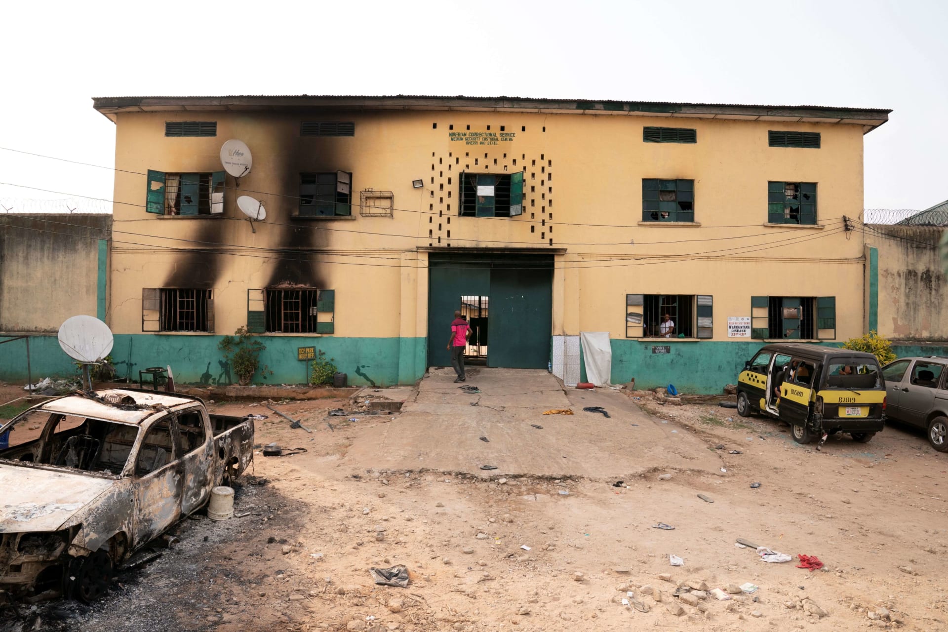 <p>A man is seen standing in front of the main gate of the Nigerian Correctional Services facility that was attacked by gunmen, with large numbers of inmates set freed afterwards in Imo State, Nigeria on April 5, 2021.</p>
