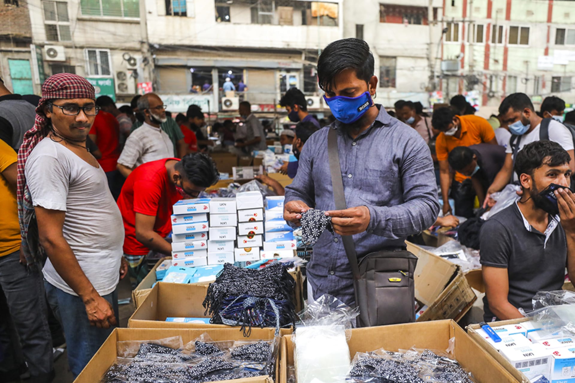 <p>A shopper peruses a mask market in Dhaka, Bangladesh, as coronavirus cases increase in April 2021.</p>
