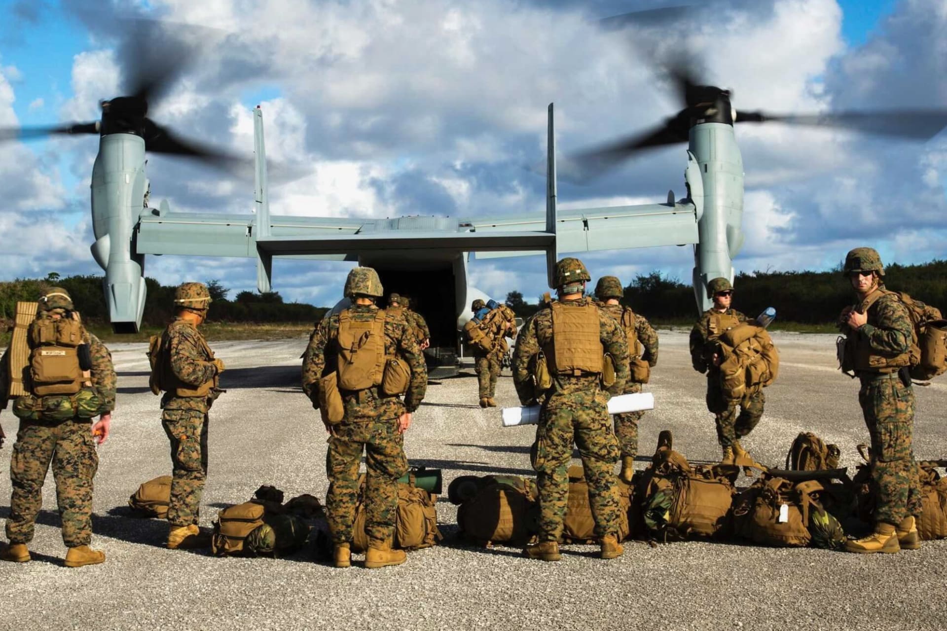 <p>An MV-22B Osprey disembarks marines on a runway in Guam. </p>
