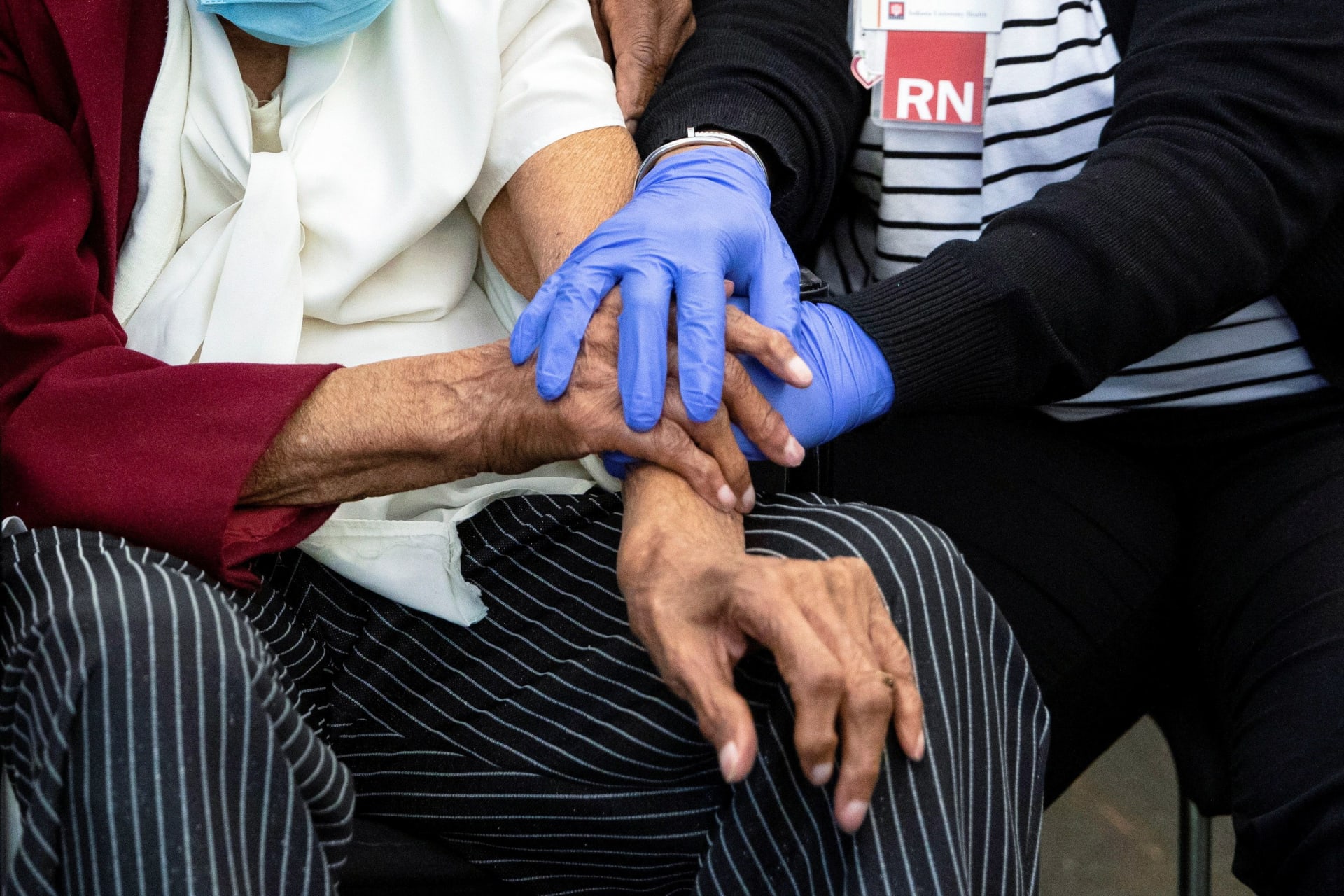 <p>Bernice Bohannon is comforted by nurse Jalissa Hurd following her COVID-19 vaccination, at the IU Health Neuroscience Center in Indianapolis, Indiana on March 16, 2021. </p>
