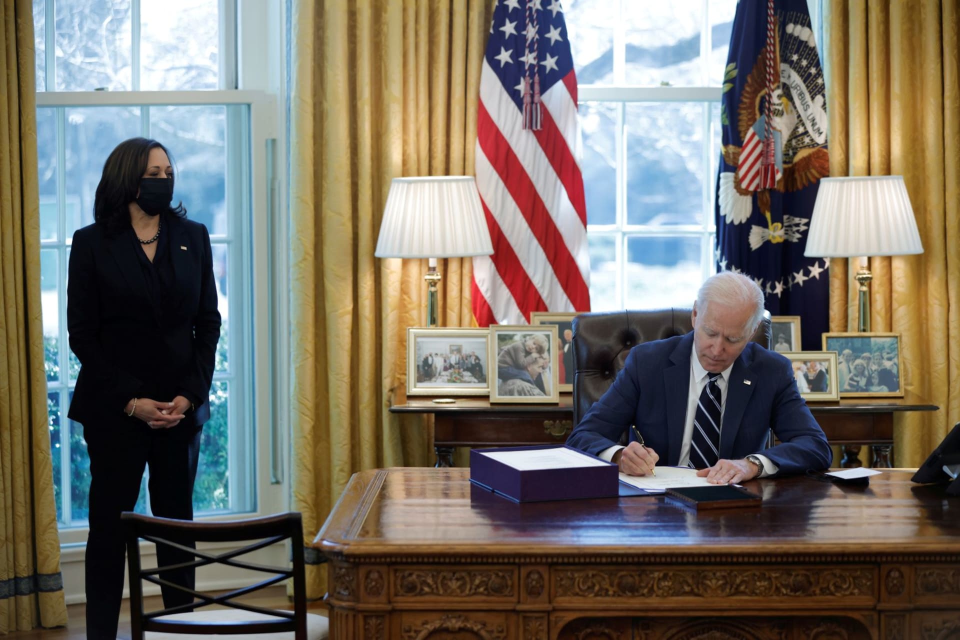 <p>President Joe Biden signs the American Rescue Plan on March 11 (accompanied by Vice President Kamala Harris).</p>
