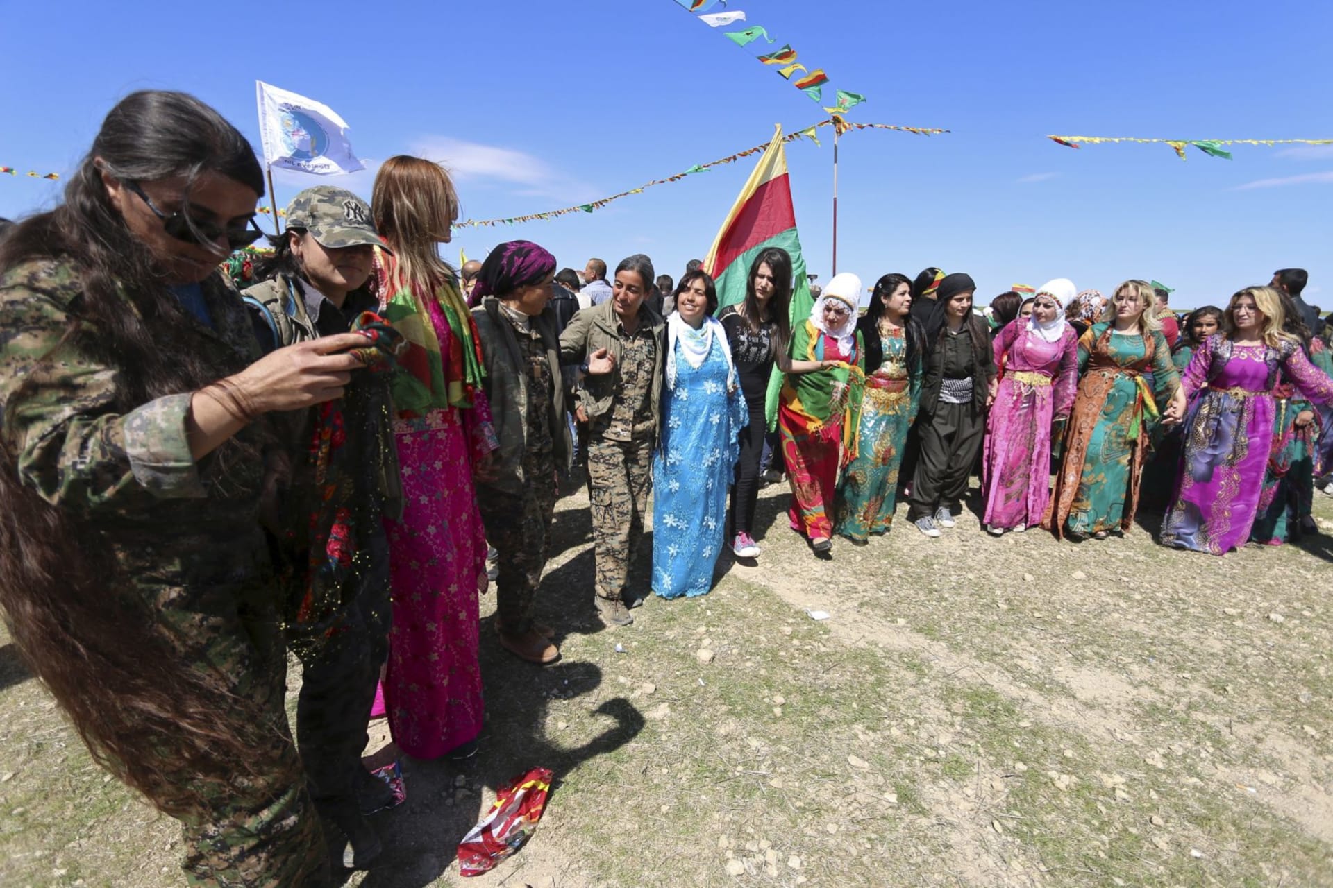 <p>Female YPJ fighters celebrate Newroz with civilian women in Qamishli, Syria in 2016. </p>
