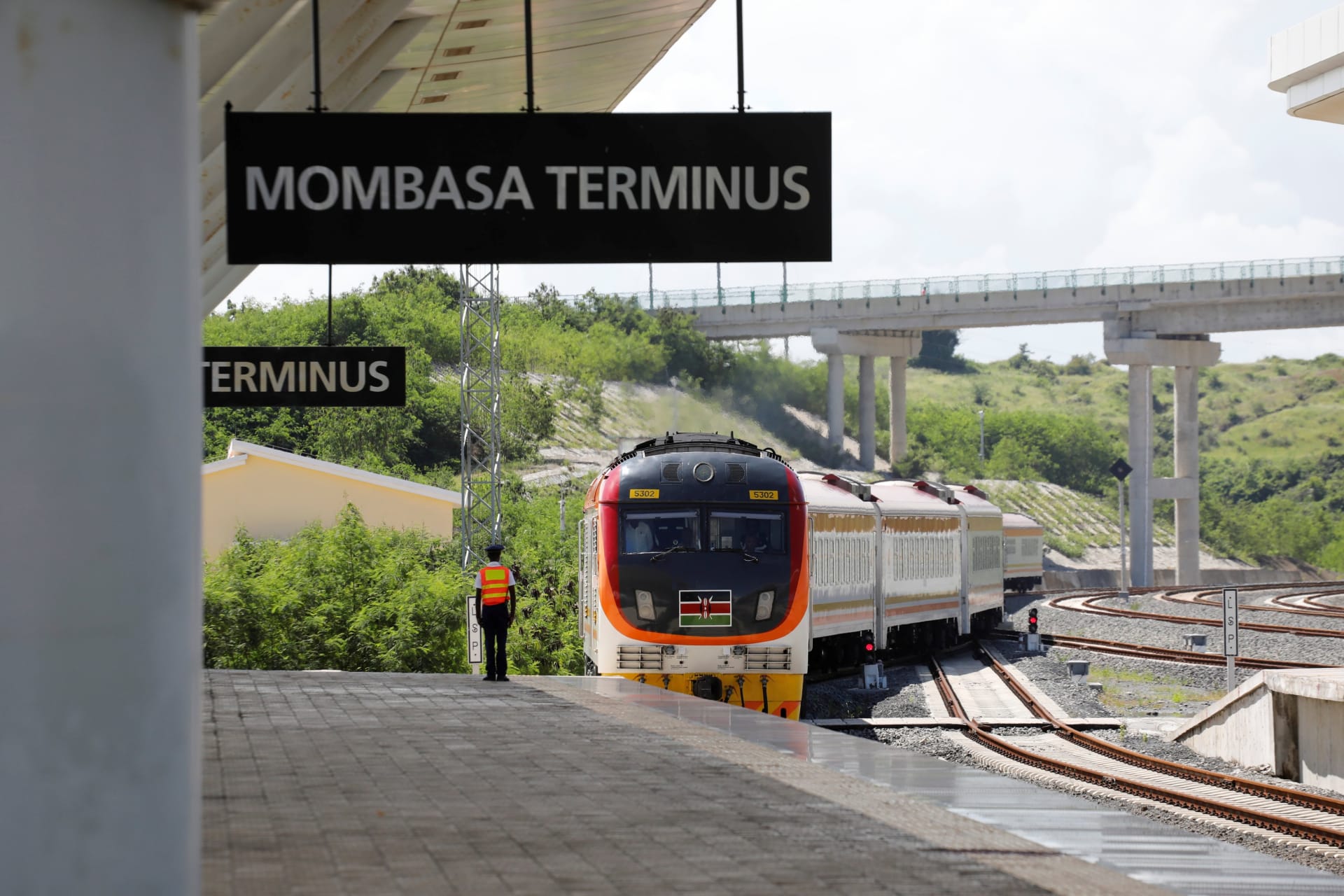 <p>A conductor waits on a platform as an SGR train traveling from Nairobi arrives at Mombasa Terminus in Mombasa, Kenya on October 24, 2019.</p>
