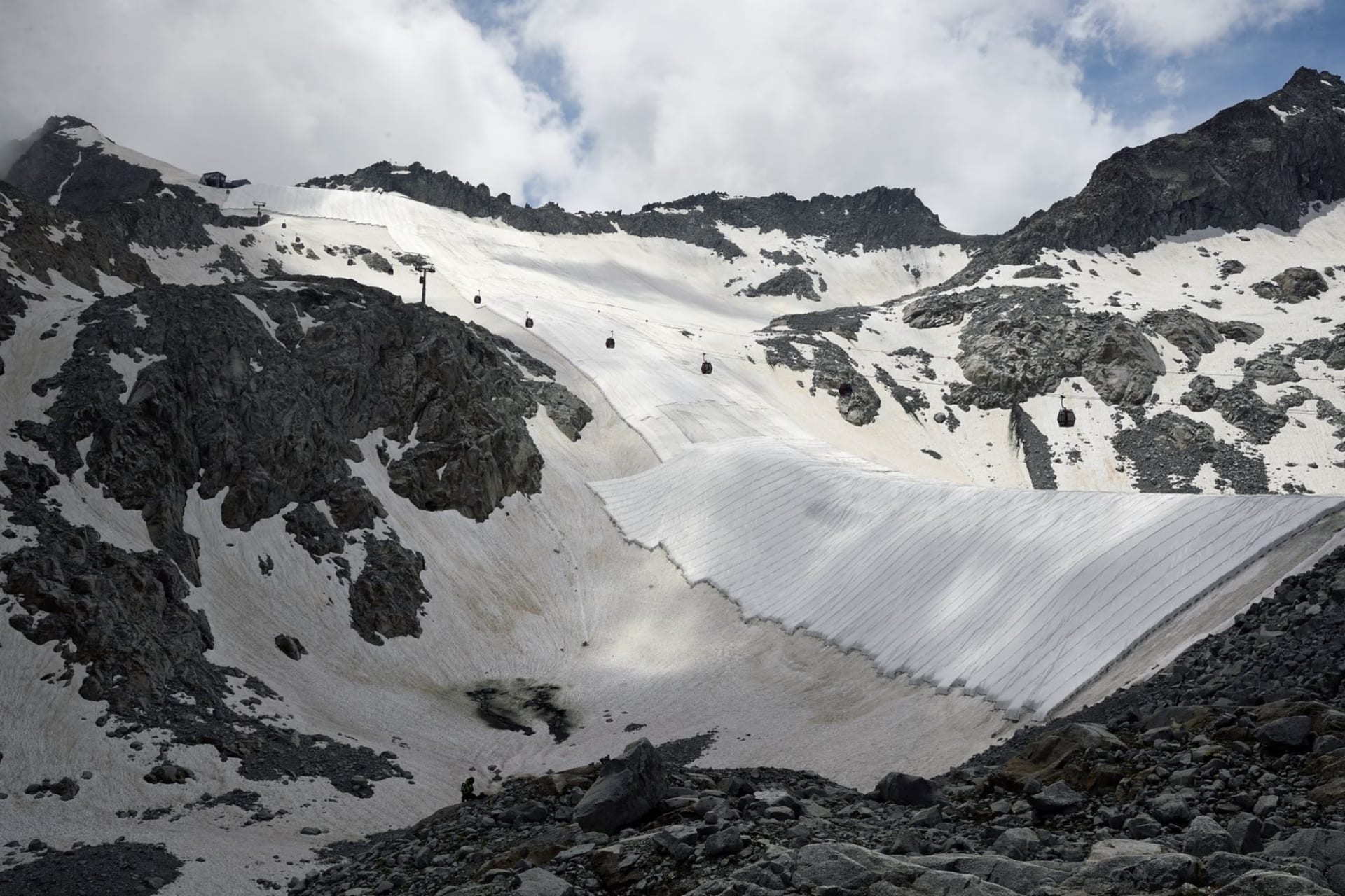 <p>Large white geotextile sheets cover northern Italy’s Presena glacier in order to delay snow melting on skiing slopes and reflect sunlight during summer months, at Passo del Tonale, near Trento, Italy on July 13, 2020. </p>
