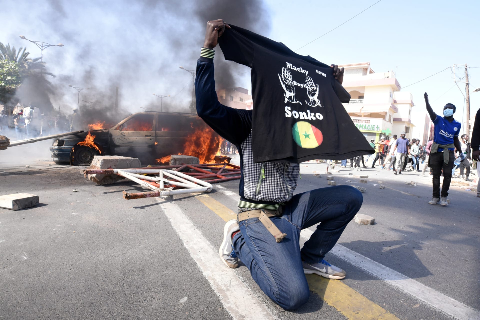 <p>A supporter of opposition leader Ousmane Sonko holds a T-shirt reading “Macky, leave Sonko” during a protest in Dakar, Senegal March 8, 2021.</p>
