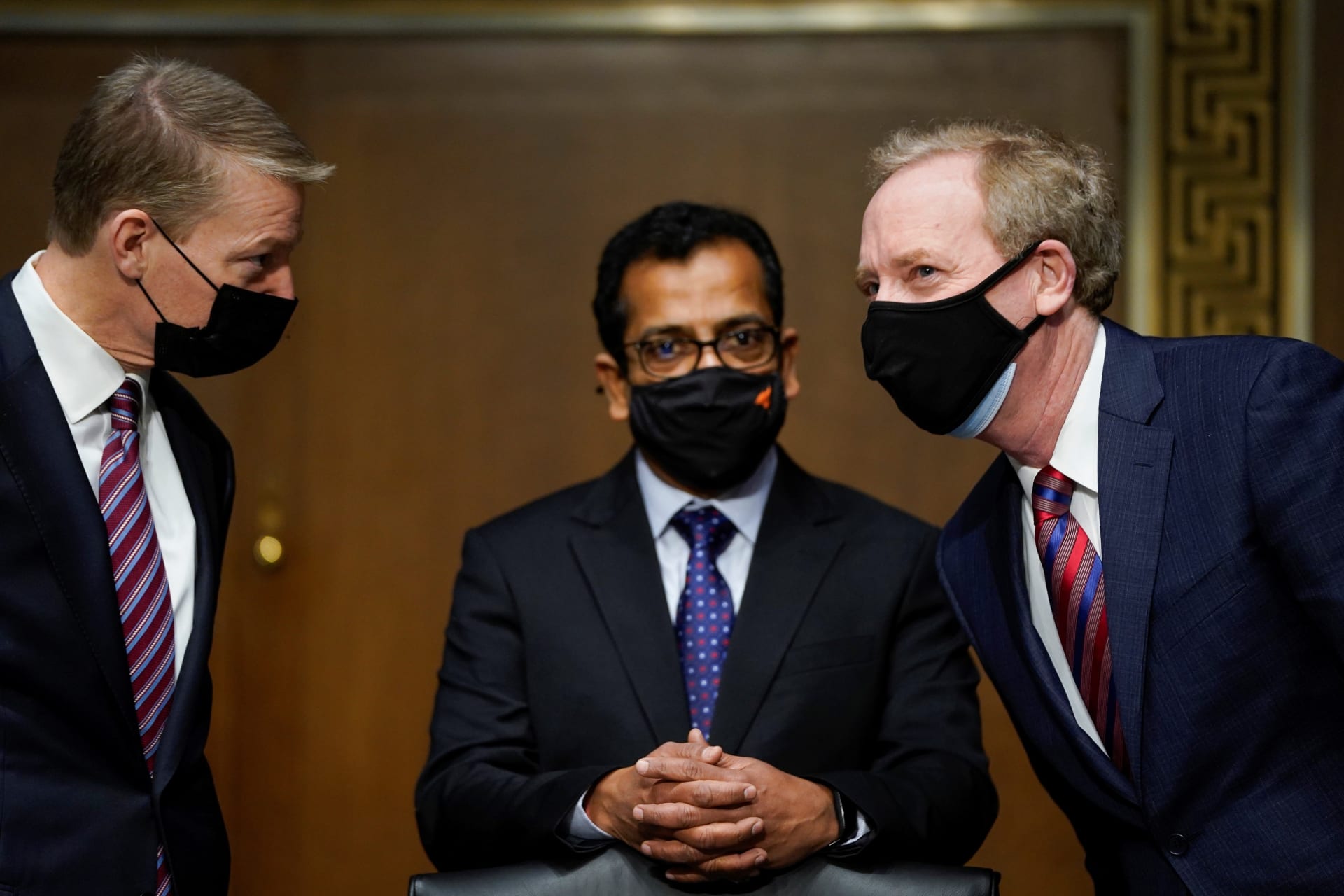 <p>FireEye CEO Kevin Mandia, SolarWinds CEO Sudhakar Ramakrishna and Microsoft President Brad Smith speak with each other before the start of a Senate Intelligence Committee hearing.</p>
