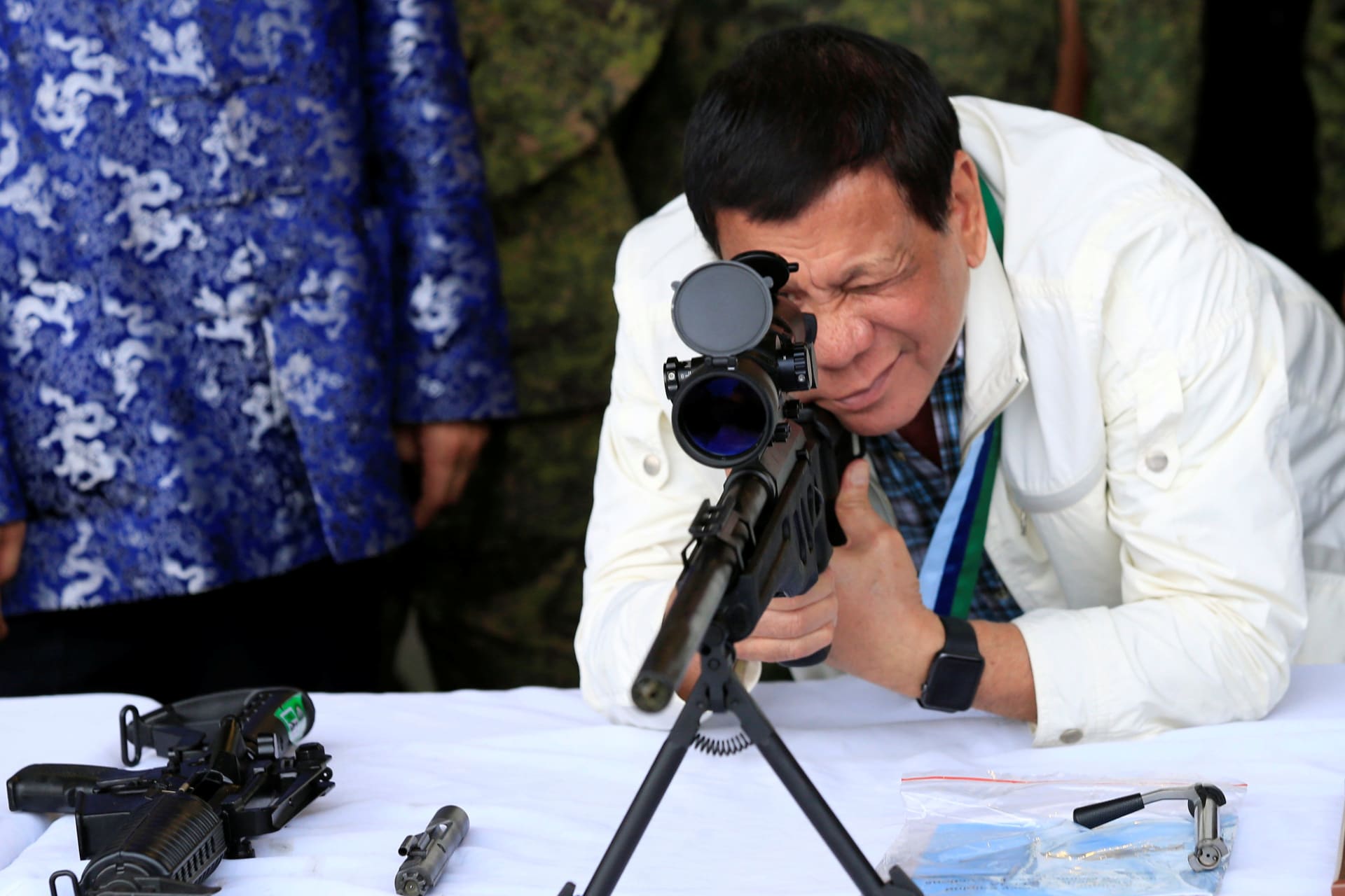 <p>Philippine President Rodrigo Duterte checks the scope of a 7.62mm sniper rifle during the turnover ceremony of China’s urgent military assistance given “gratis” to the Philippines, at Clark Air Base, near Angeles City, Philippines, on June 28, 2017. </p>
