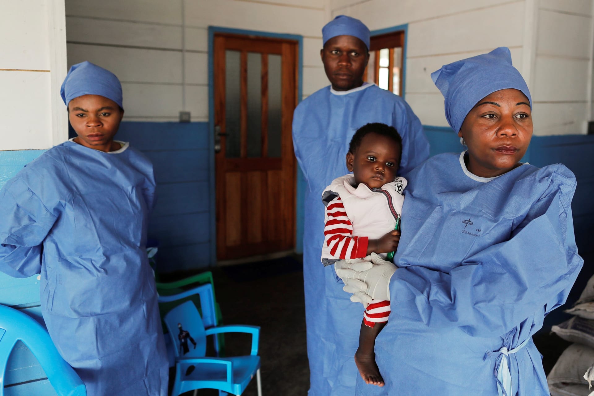 <p>Arlette Kavugho, an Ebola survivor who works as a caregiver, carries Kambale Eloge, whose mother died of Ebola, in Katwa, near Butembo, in the Democratic Republic of Congo, on October 2, 2019.</p>
