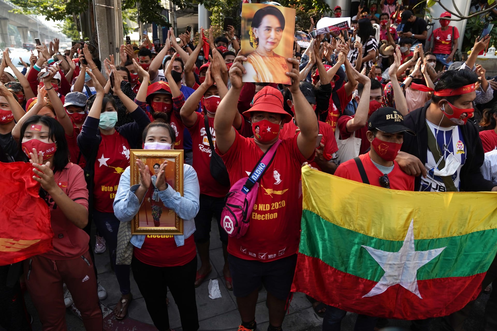 <p>NLD supporters clap outside Myanmar’s embassy in Bangkok, Thailand.</p>
