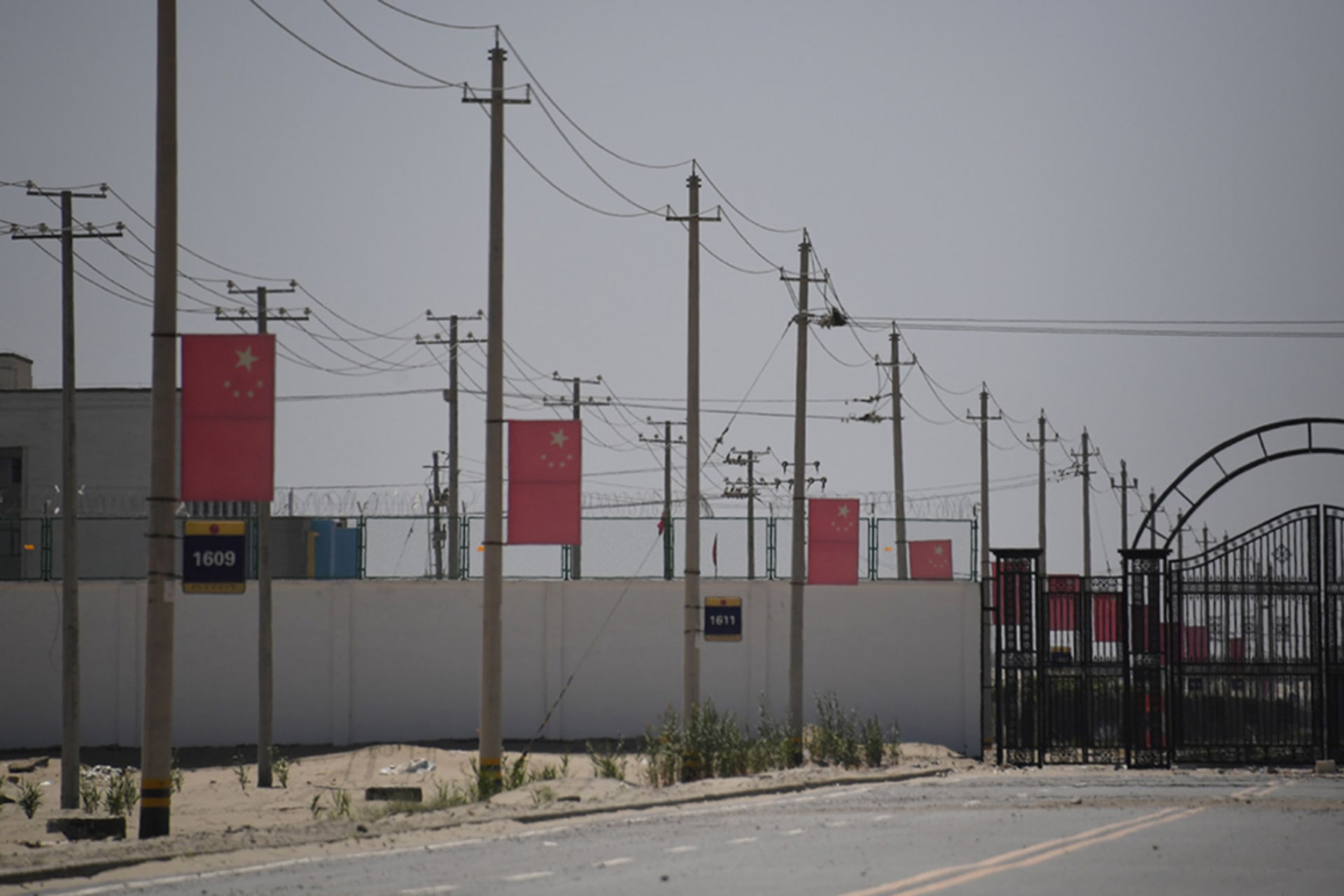 <p>Chinese flags on a road leading to a facility in China’s northwestern Xinjiang region believed to be a reeducation camp where mostly Muslim ethnic minorities are detained. </p>
