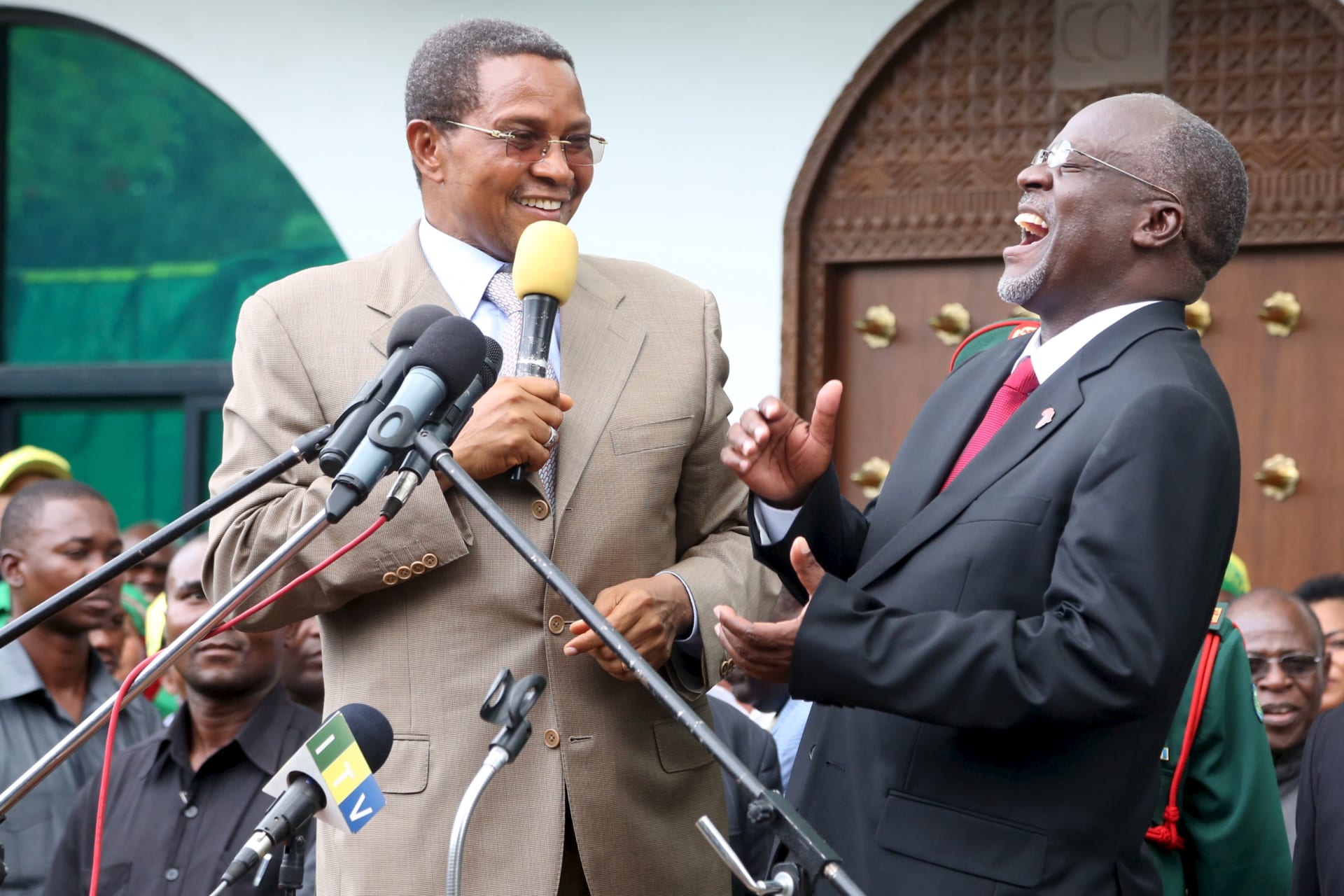 <p>Tanzania’s President-elect John Pombe Magufuli (R) and outgoing President Jakaya Kikwete share a moment before addressing members of the ruling Chama Cha Mapinduzi (CCM) at the party’s sub-head office in Dar es Salaam on October 30, 2015.</p>
