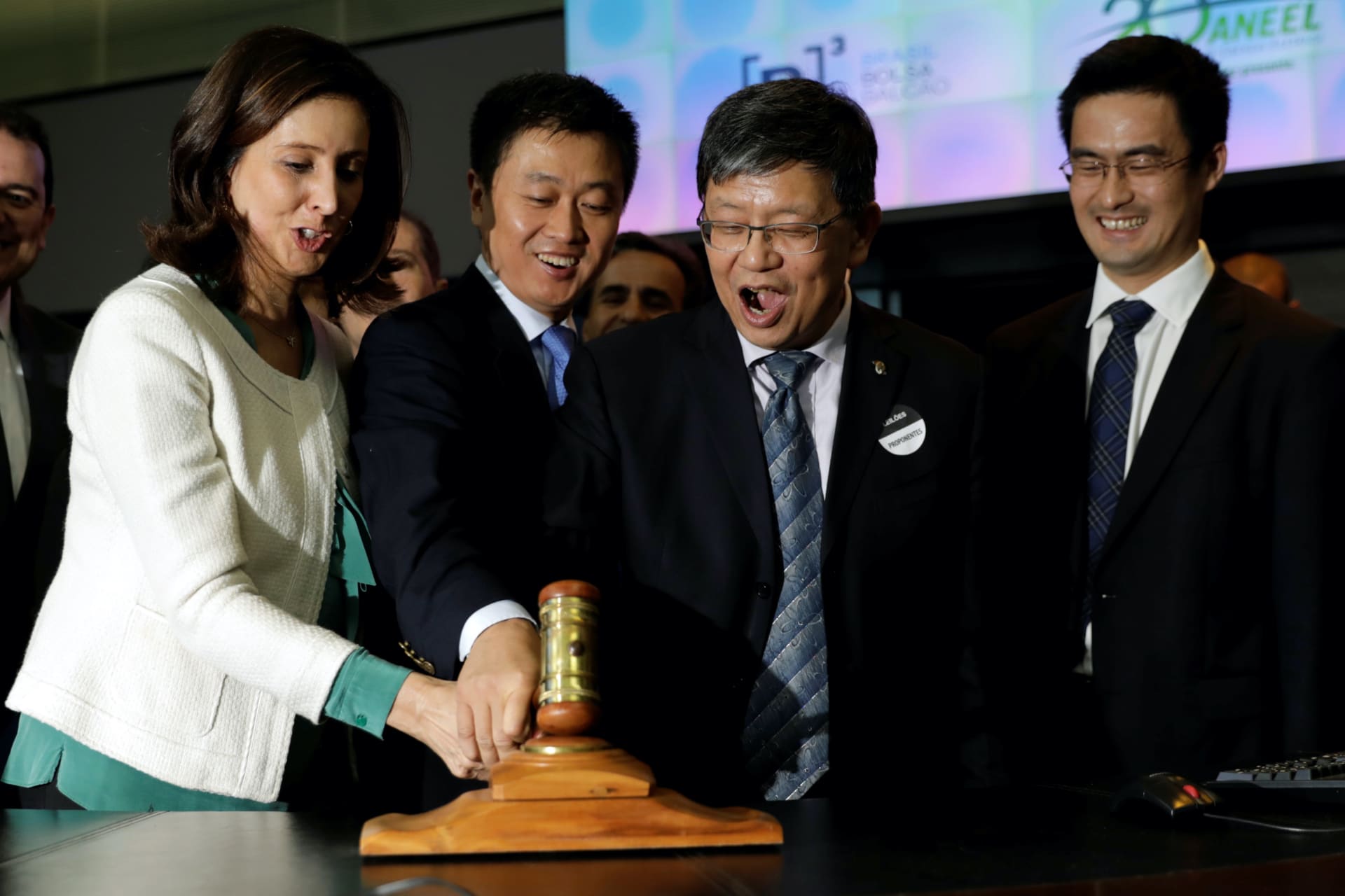 <p>China’s State Power Investment Corp representatives react during Brazilian government auction of operating licenses for four hydroelectric plants in São Paulo, Brazil on September 27, 2017.</p>

