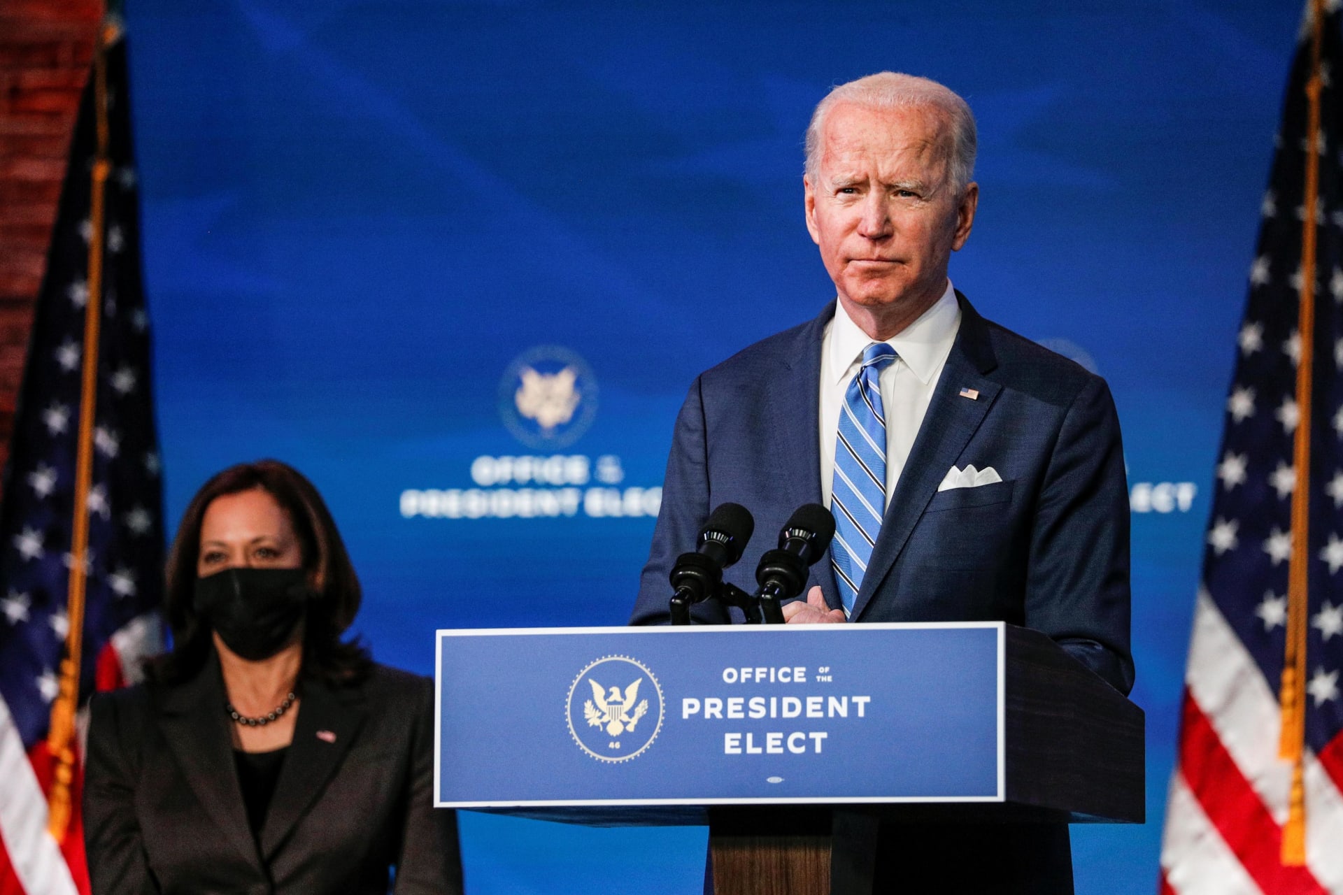 <p>Vice President-Elect Kamala Harris sits behind President-Elect Joe Biden as he proposes an economic relief package to combat the effects of the COVID-19 pandemic in Wilmington, Delaware, on January 14, 2021. </p>
