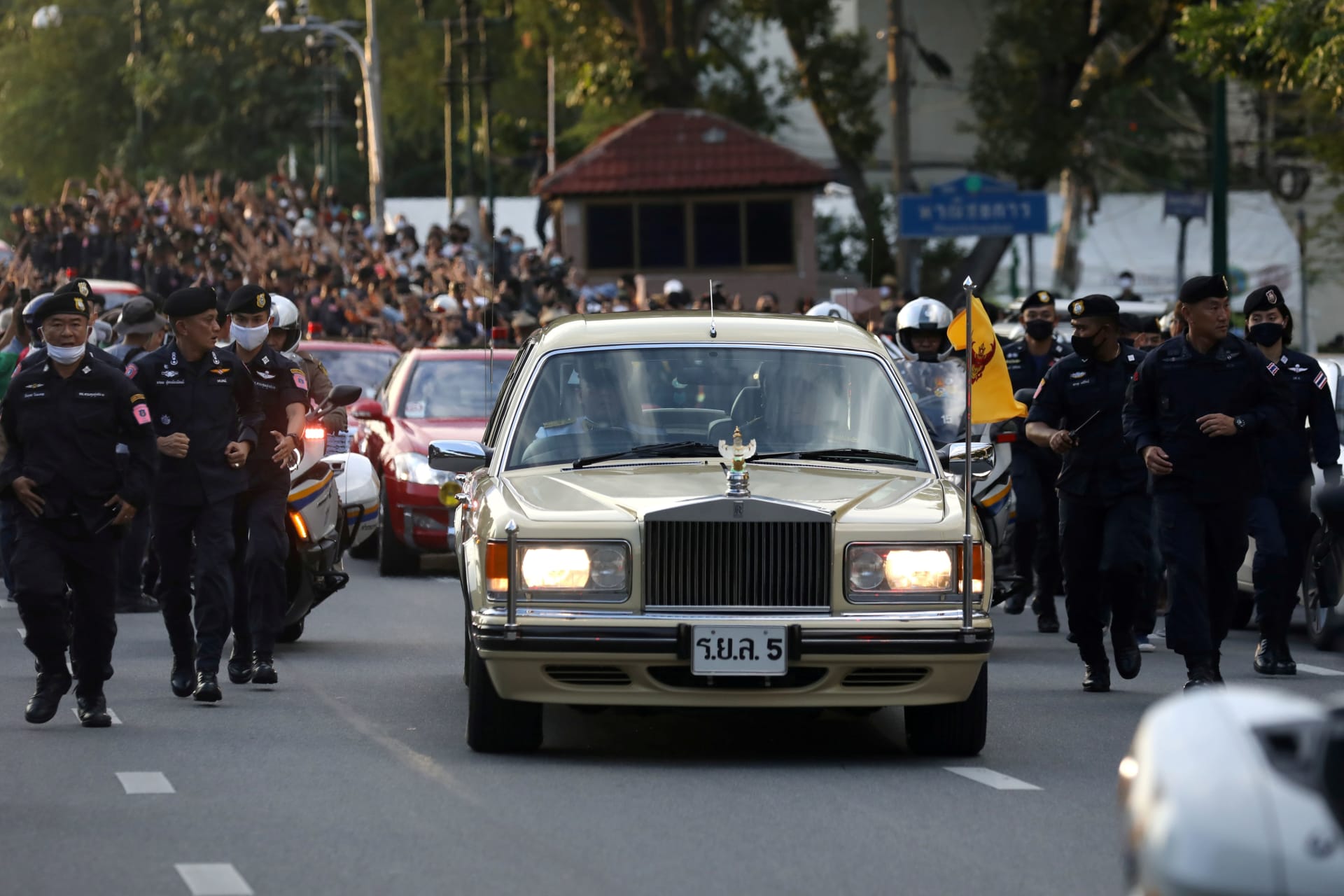 <p>A car of the royal motorcade drives past a Thai antigovernment mass protest, on the 47th anniversary of the 1973 student uprising, in Bangkok, Thailand on October 14, 2020.</p>
