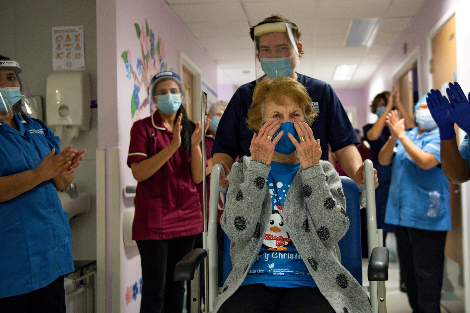 <p>Margaret Keenan is applauded after she becomes the first person to receive a COVID-19 vaccine outside of clinical trials in Coventry, England, on December 8, 2020. </p>

