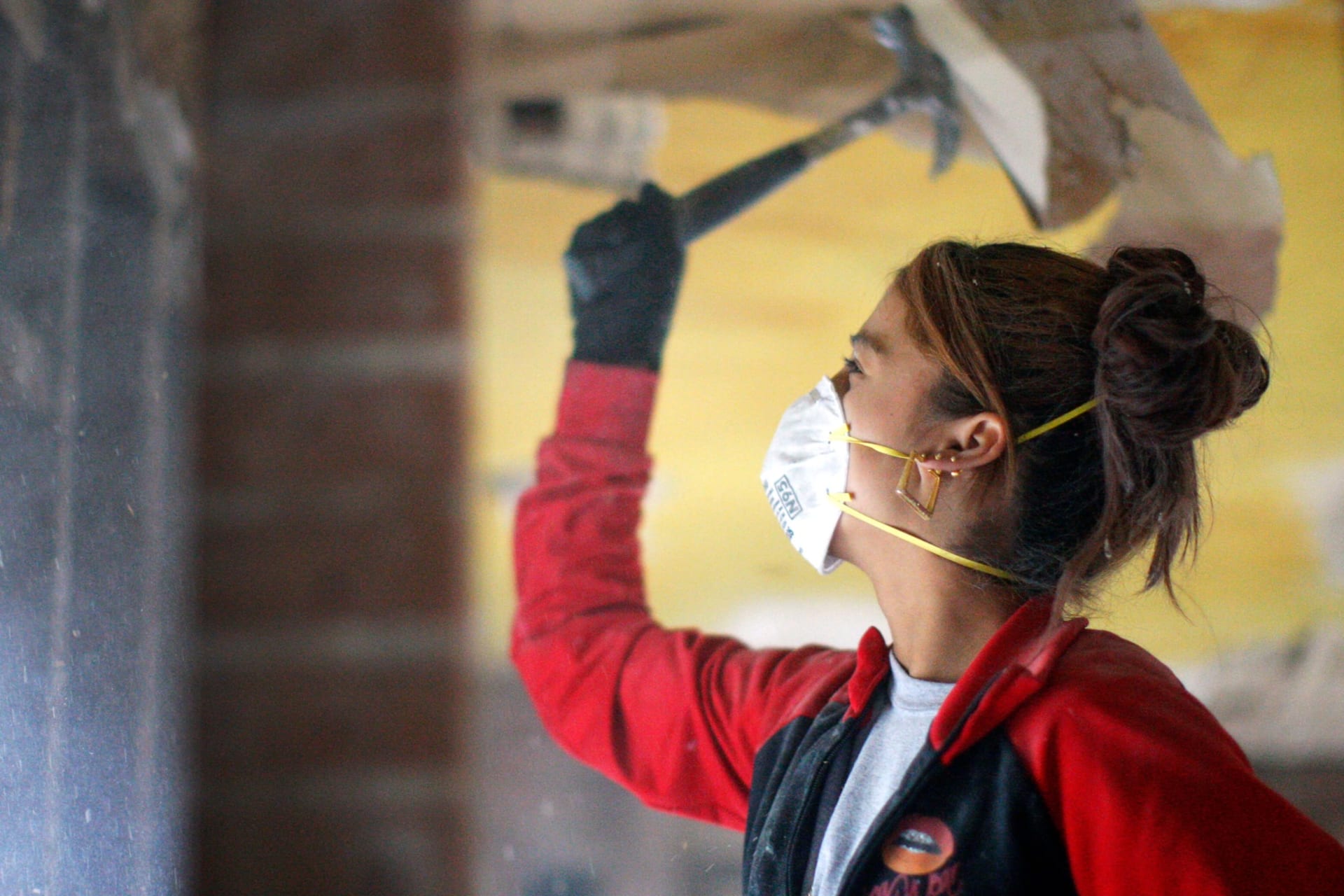 <p>An AmeriCorps worker helps gut a house being renovated for affordable housing.</p>
