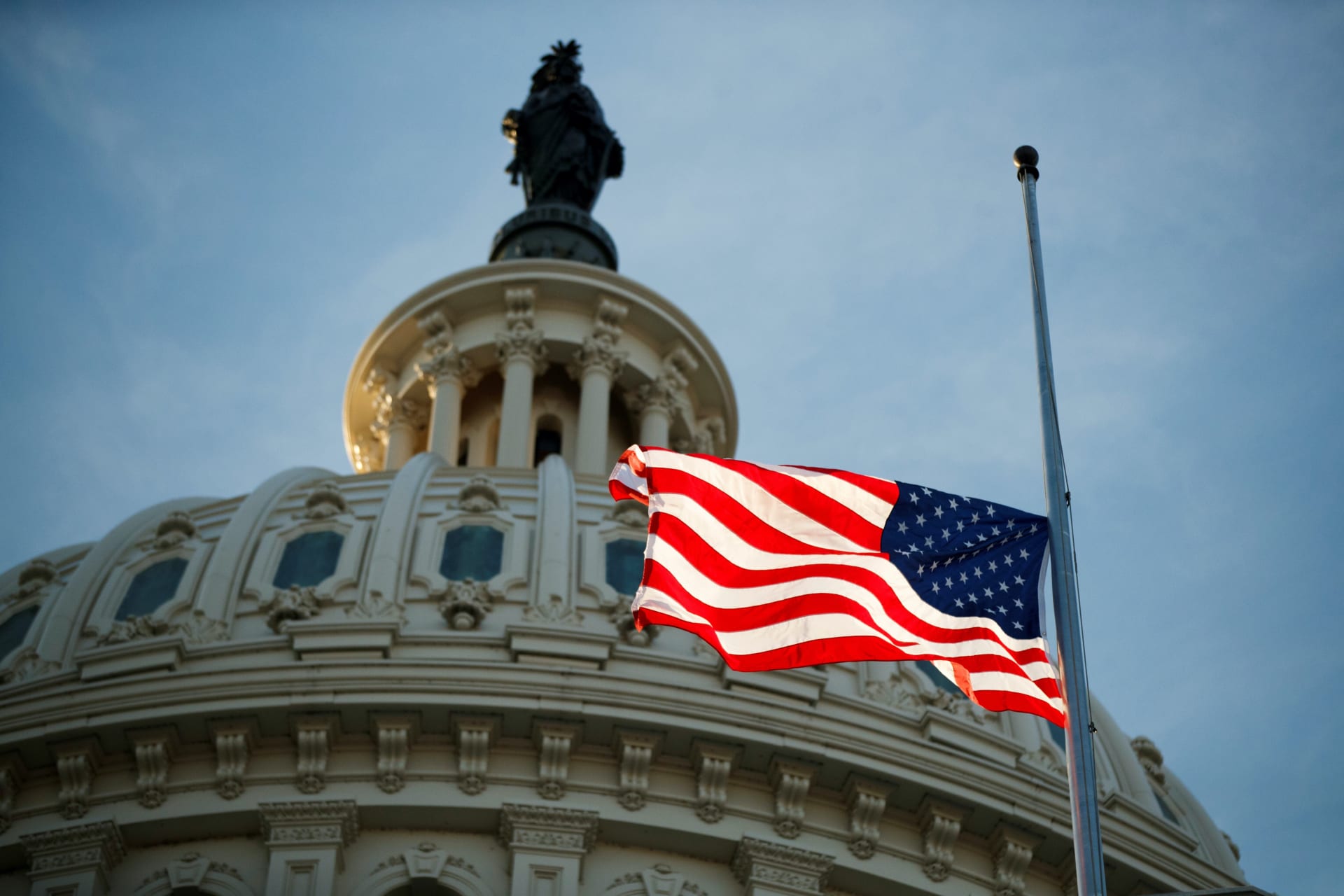 <p>The American flag flying at half staff at the United States Capitol on December 3, 2018. Shawn Thew/Pool via Reuters</p>
