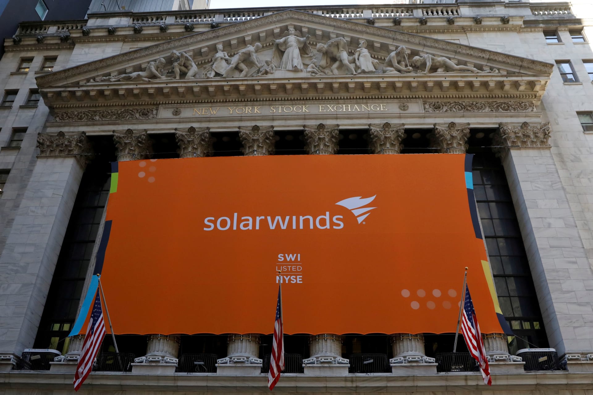 <p>SolarWinds Corp banner hangs at the New York Stock Exchange.</p>
