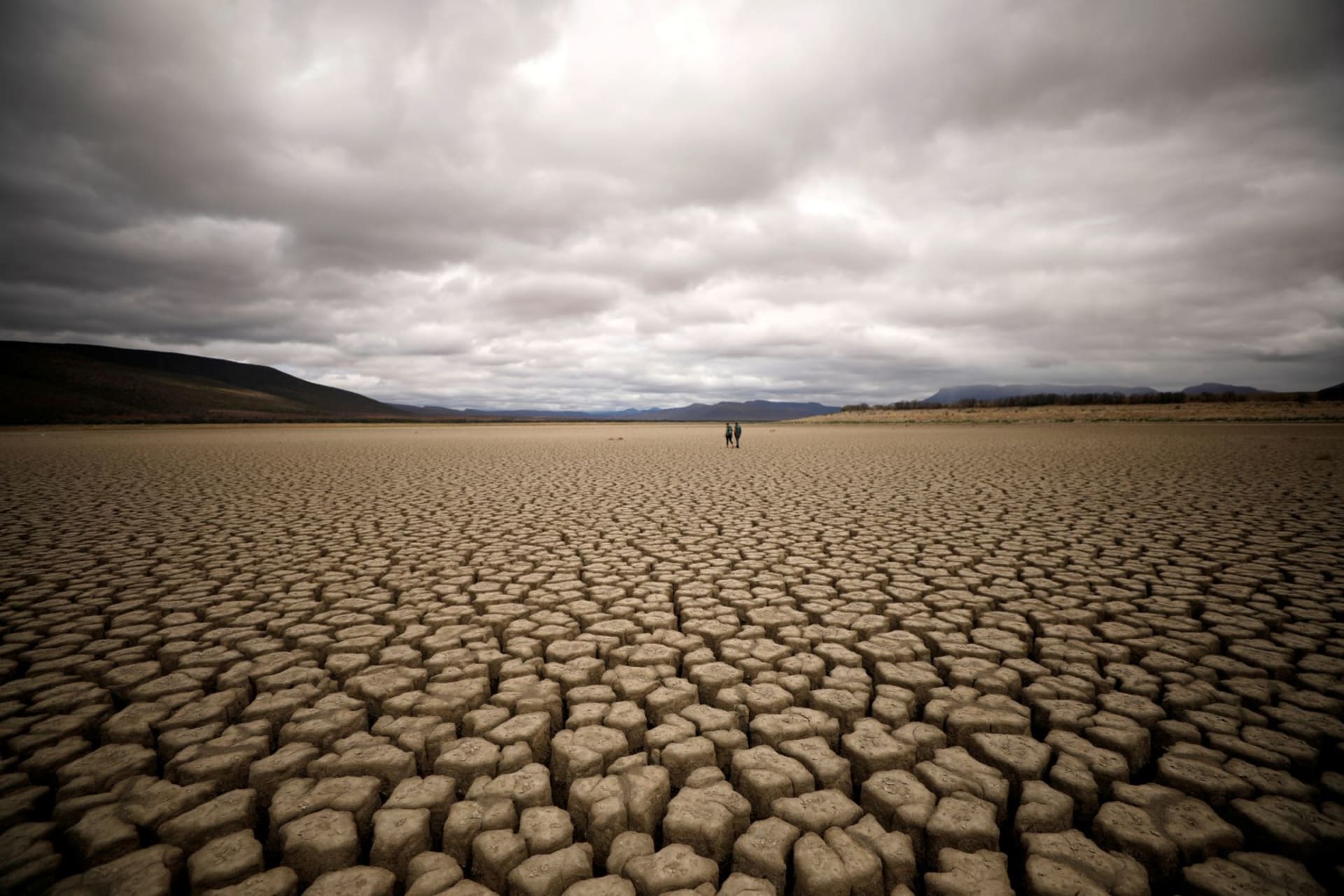 <p>Clouds gather but produce no rain as cracks are seen in the dried up municipal dam in drought-stricken Graaff-Reinet, South Africa on November 14, 2019. </p>
