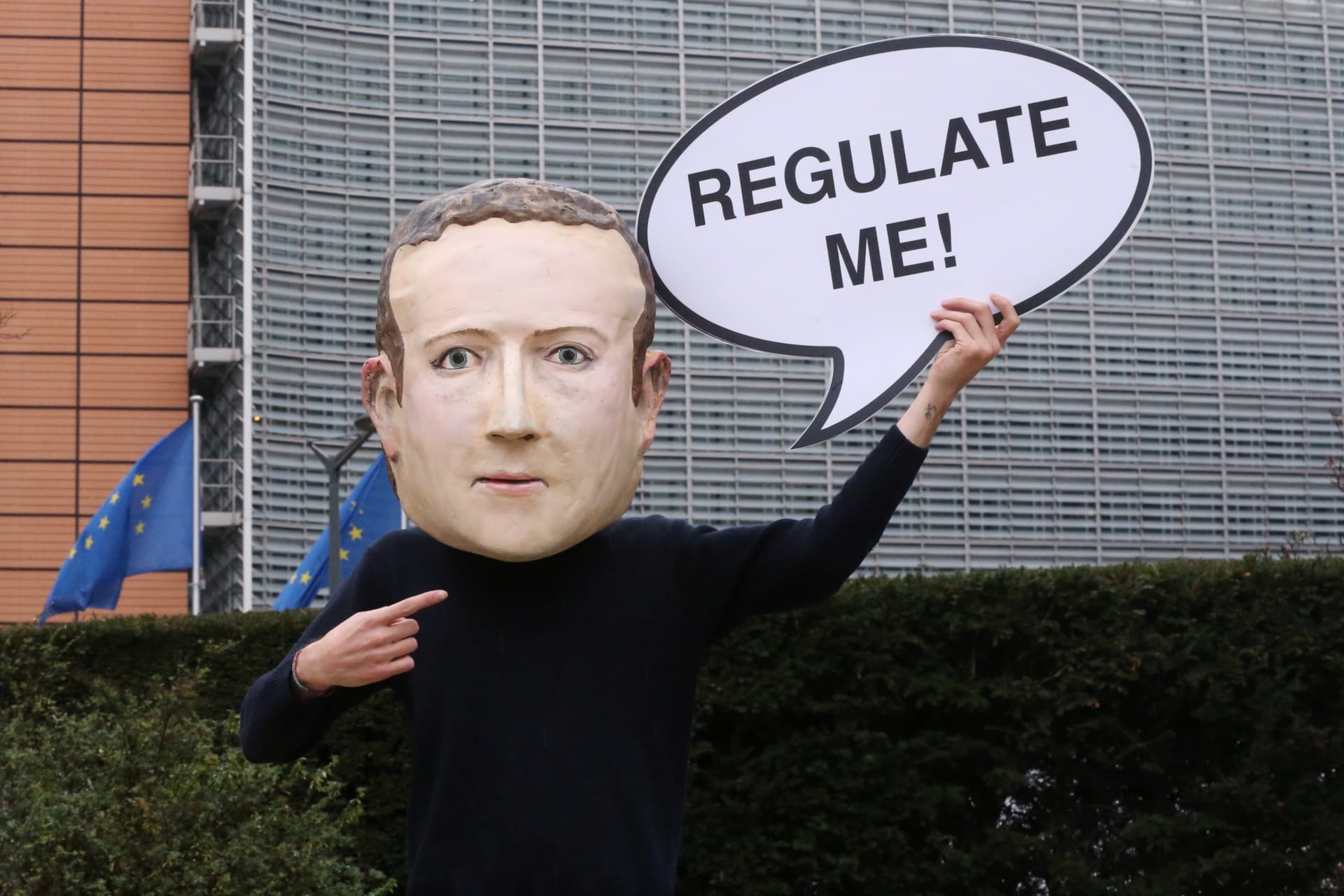 <p>An activist of Avaaz wears a mask depicting the face of Facebook CEO Mark Zuckerberg during a protest in Brussels.</p>
