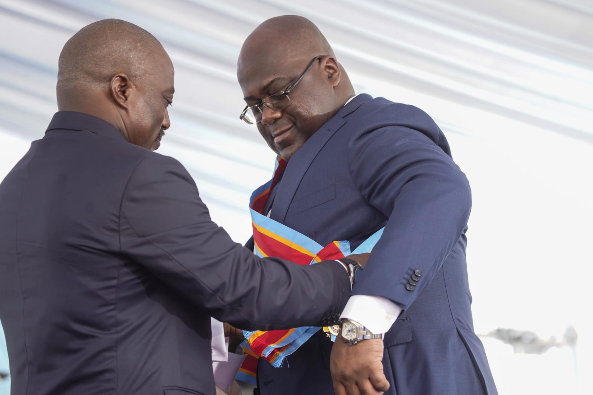 <p>Félix Tshisekedi receives the presidential sash from the outgoing President Joseph Kabila during the inauguration ceremony whereby Tshisekedi was sworn into office as the new president of the Democratic Republic of Congo, Kinshasa, DRC, January 24, 2019.</p>
