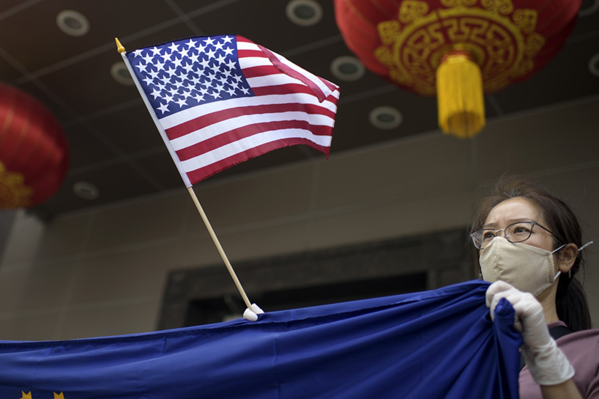 <p>A protester holds a U.S. flag outside of the Chinese consulate in Houston after the U.S. State Department ordered China to close the consulate.</p>
