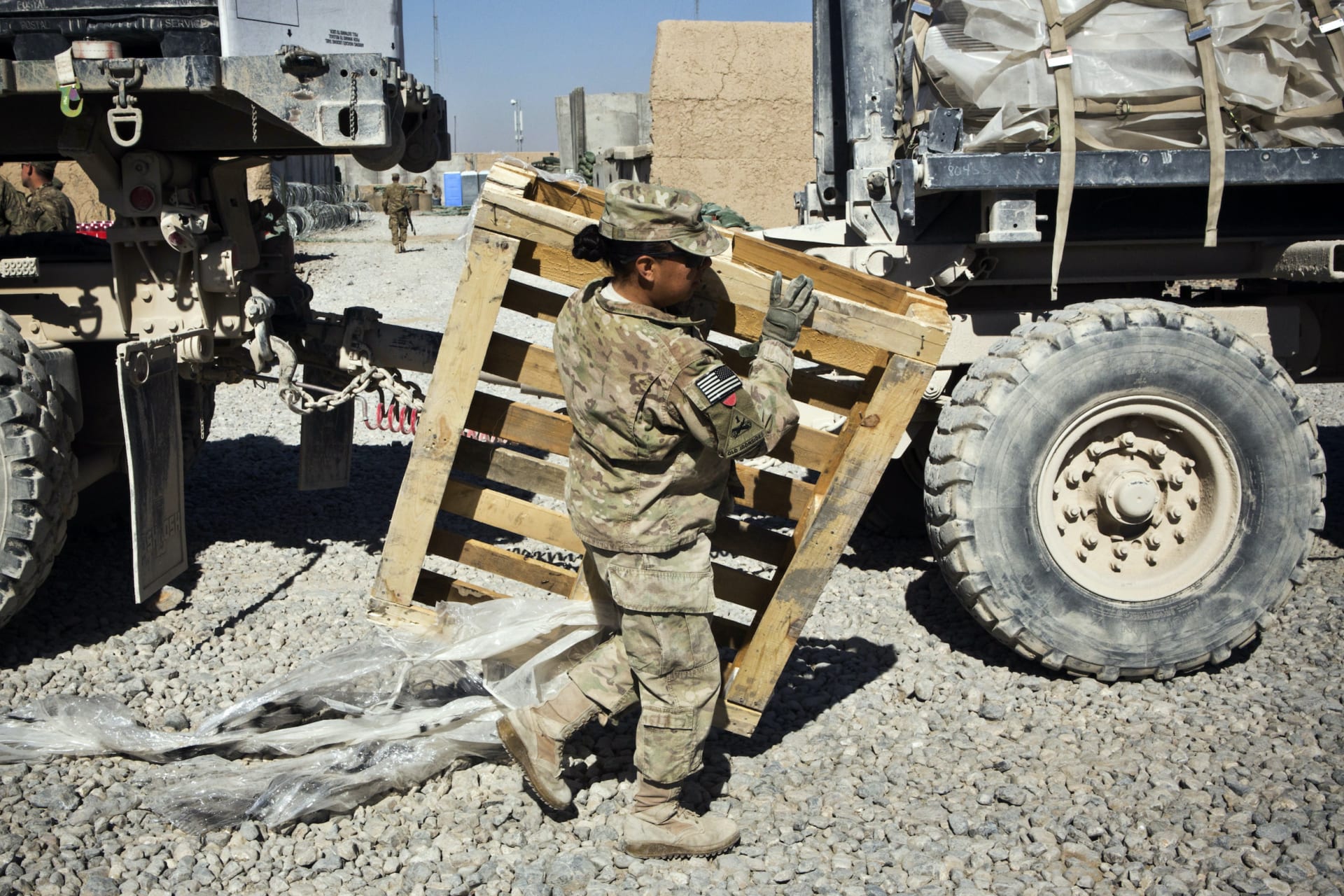 Specialist Joanne Read, of the U.S. Army's Bravo Company, 1st Battalion, 36th Infantry Regiment, First Armored Division, helps unload a resupply truck at Command Outpost AJK in Maiwand District, Kandahar Province, Afghanistan, January 24, 2013. REUTERS/An