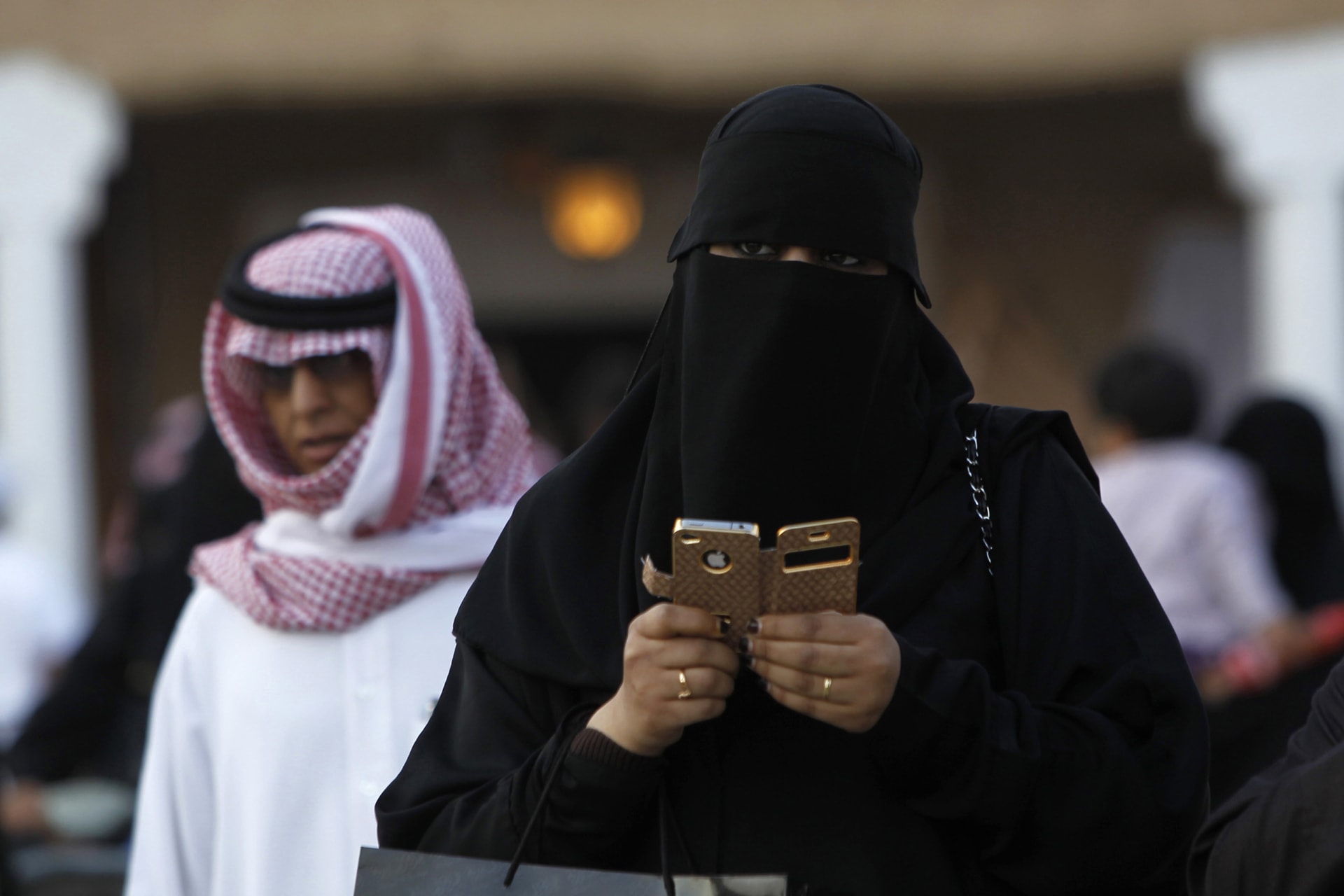 <p>woman using an iPhone visiting the 27th Janadriya festival on the outskirts of Riyadh.</p>
