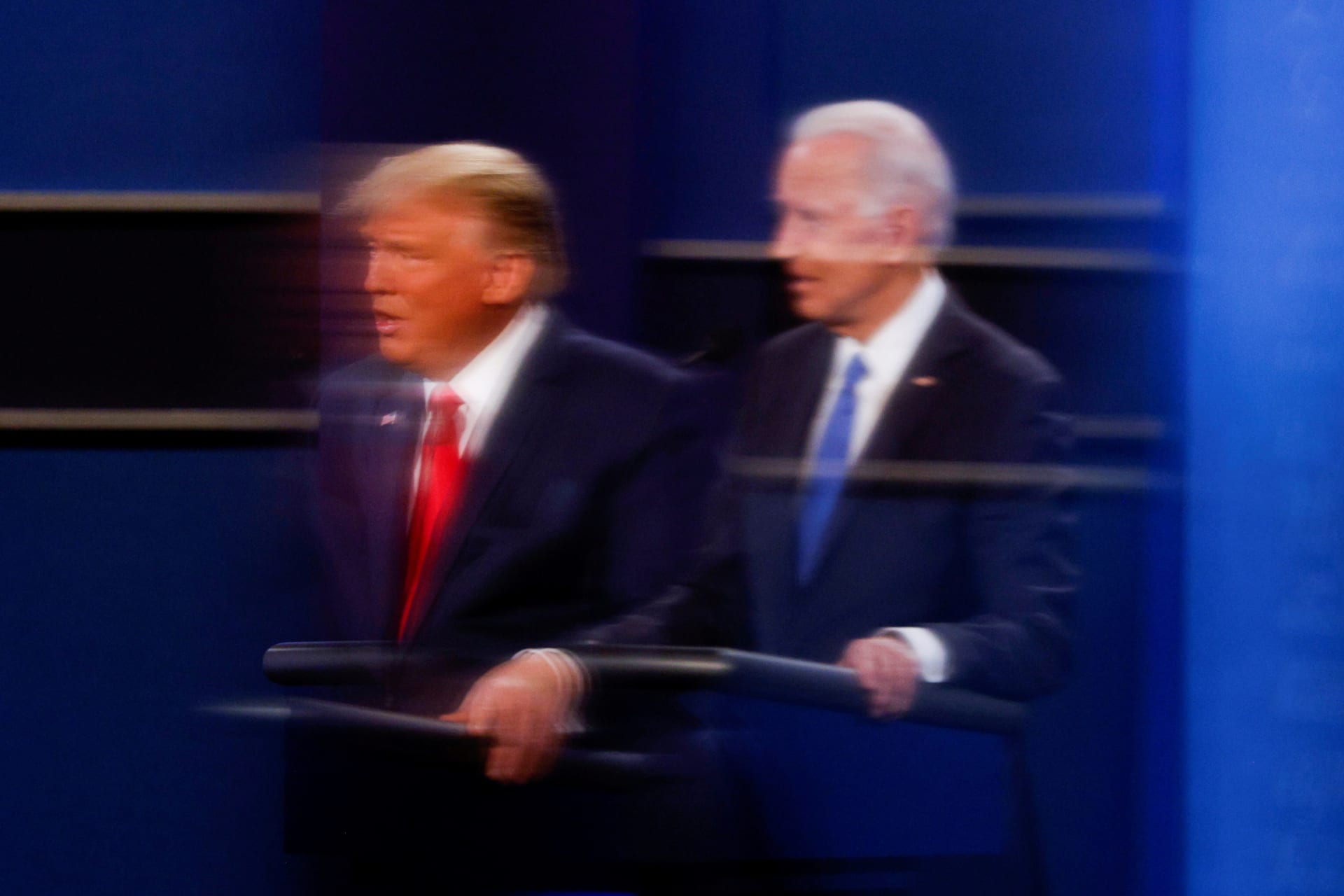 <p>U.S. President Donald Trump and Democratic presidential nominee Joe Biden are reflected in the plexiglass protecting a TV camera operator from coronavirus as they participate in their second 2020 presidential campaign debate.</p>
