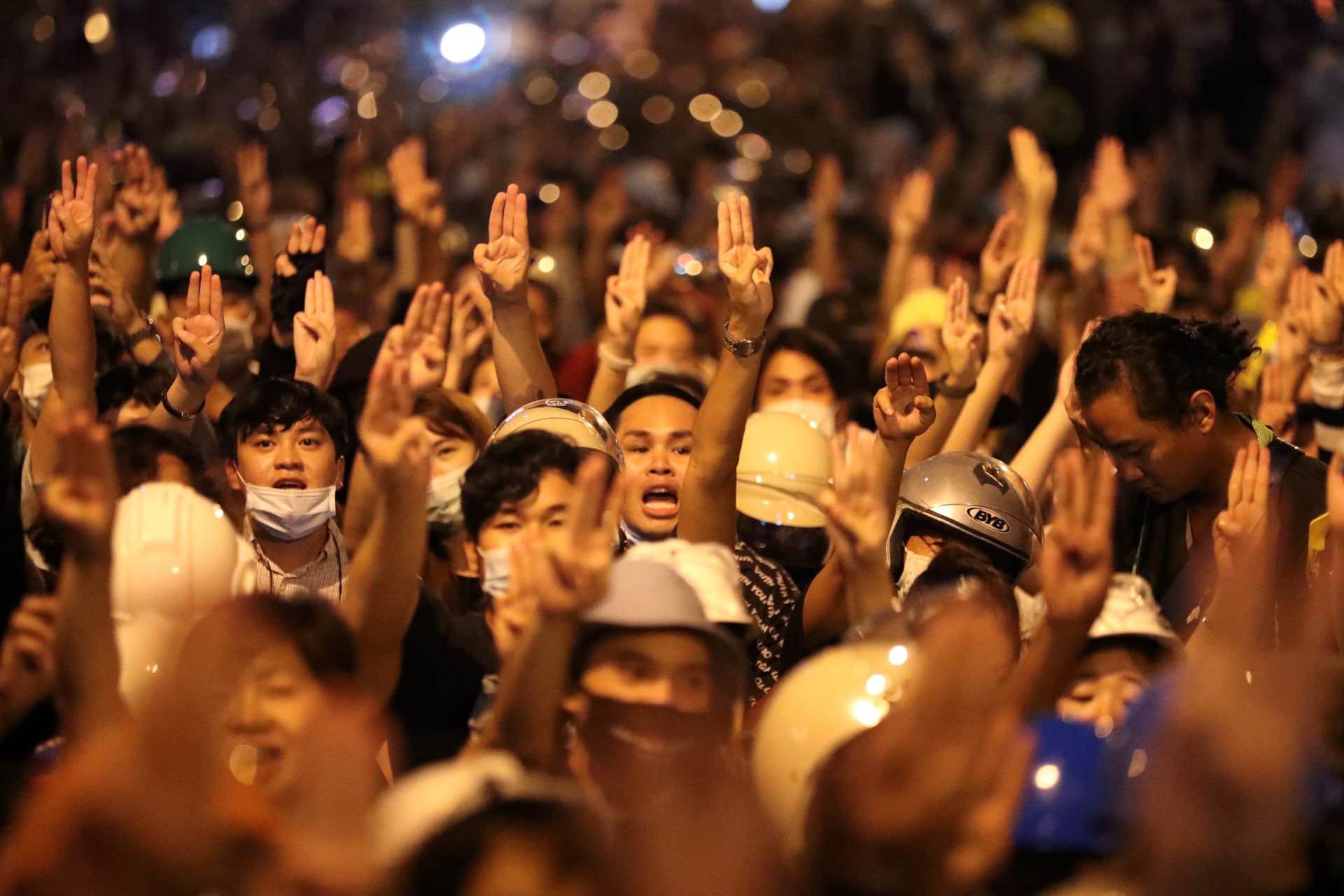 <p>People show the three-fingered salute during a protest, in Bangkok, Thailand on October 26, 2020.</p>
