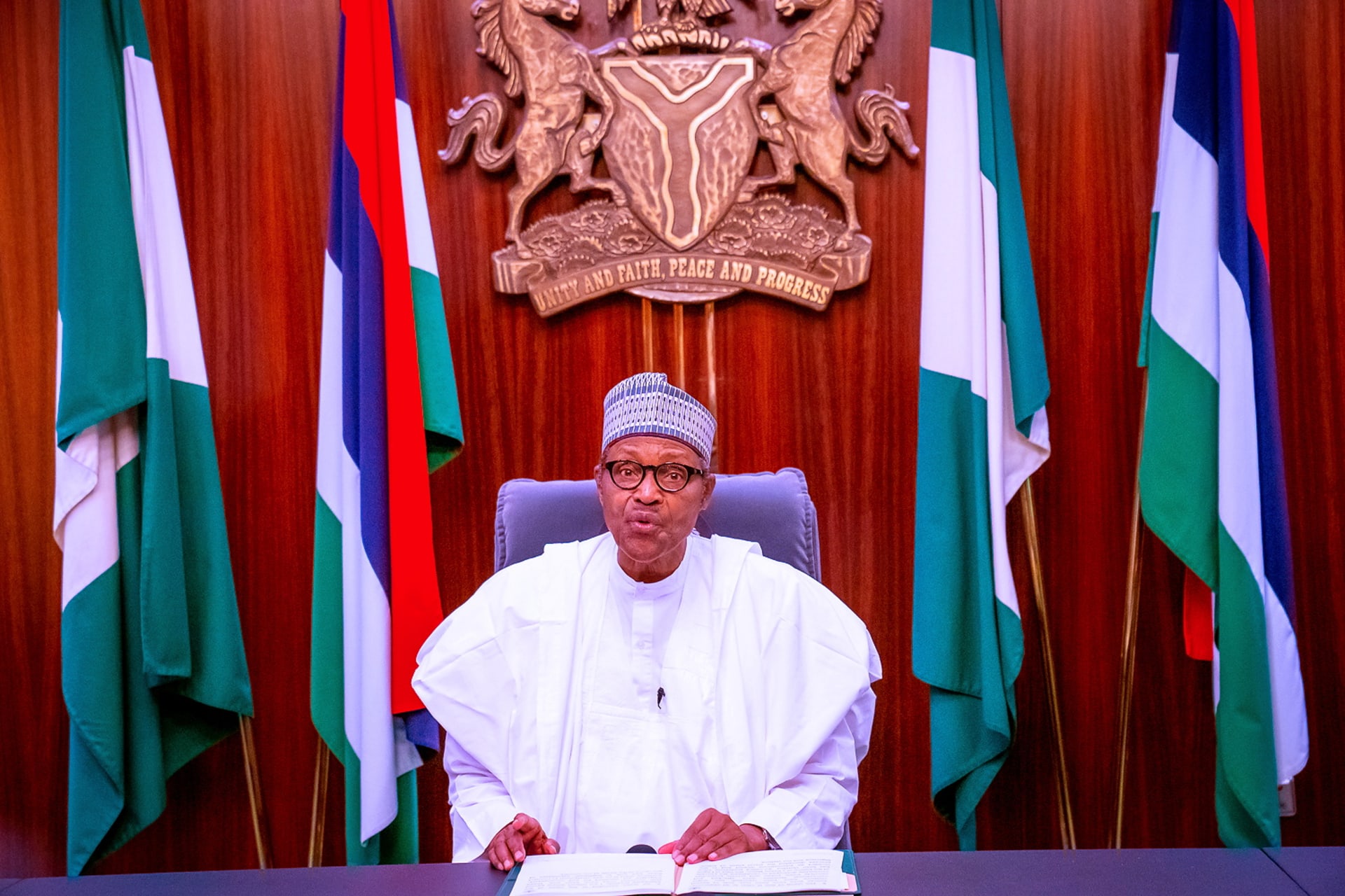 <p>Nigerian President Muhammadu Buhari sits before giving a televised address in Abuja, Nigeria on October 22, 2020.</p>
