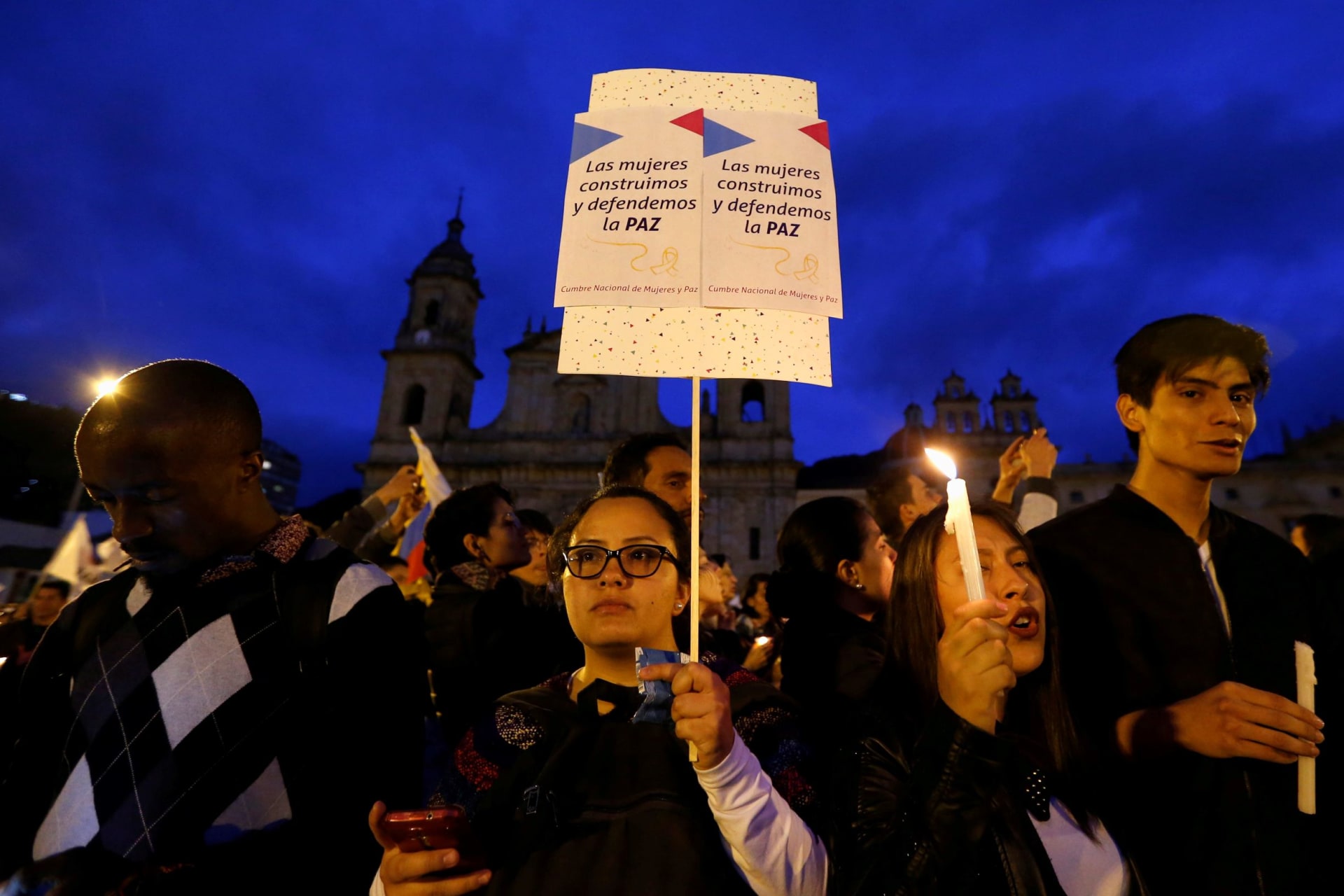 <p>A protester carries a sign that says, “The women build and defend the peace,” following the deaths of activists in Colombia in 2018.</p>