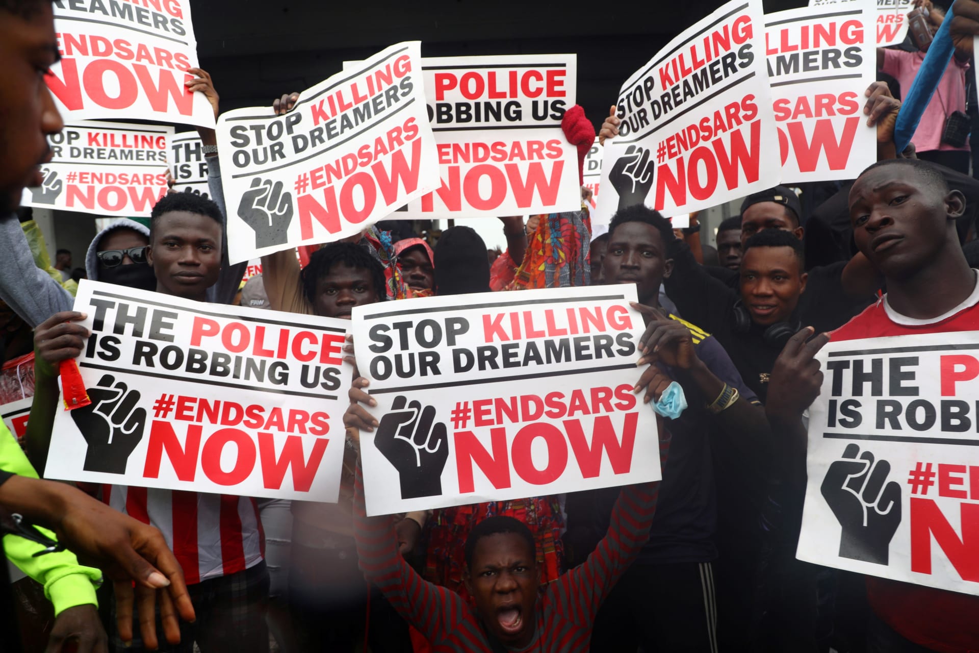 <p>Demonstrators carry banners during a protest over alleged police brutality, in Lagos, Nigeria on October 14, 2020.</p>
