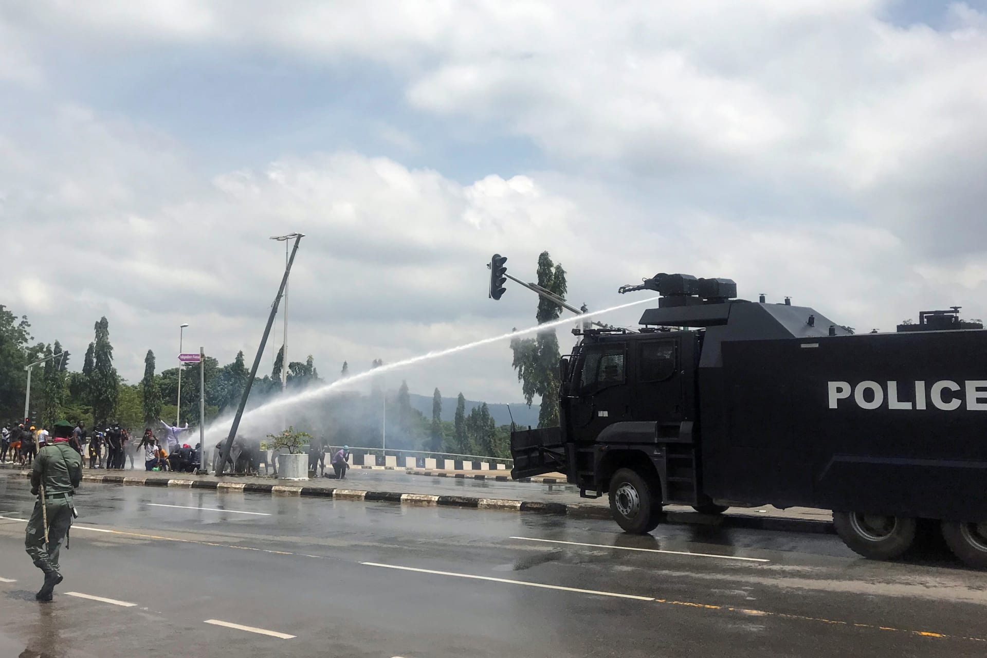 <p>Police use water cannons to disperse people protesting against alleged brutality by members of Nigeria’s Special Anti-Robbery Squad (SARS), in Abuja, Nigeria on October 11, 2020.</p>
