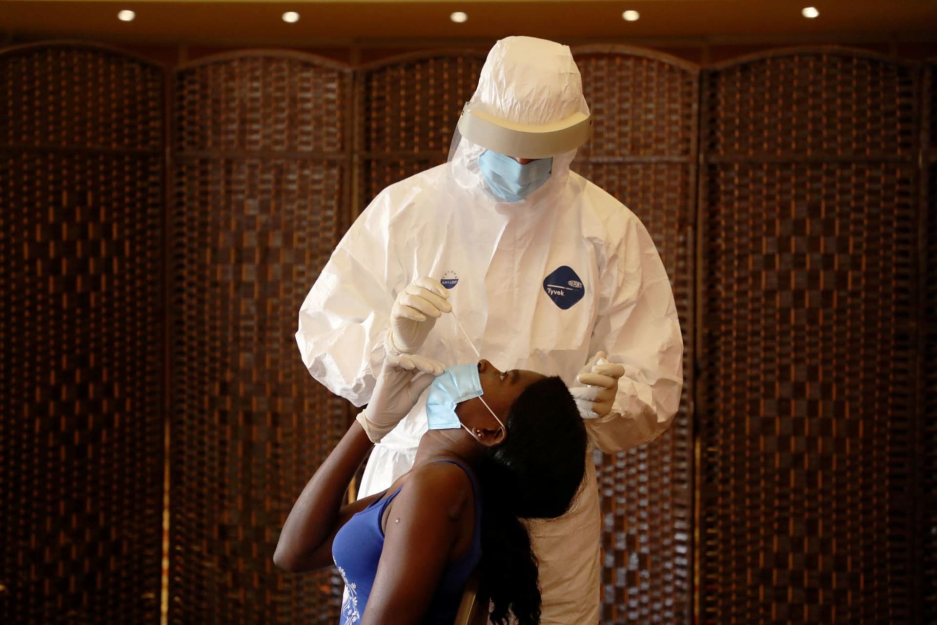 <p>A health worker tests a migrant domestic worker from Africa for the novel coronavirus at a hotel, before she travels back to her country, in the Beirut suburbs of Lebanon on October 5, 2020.</p>
