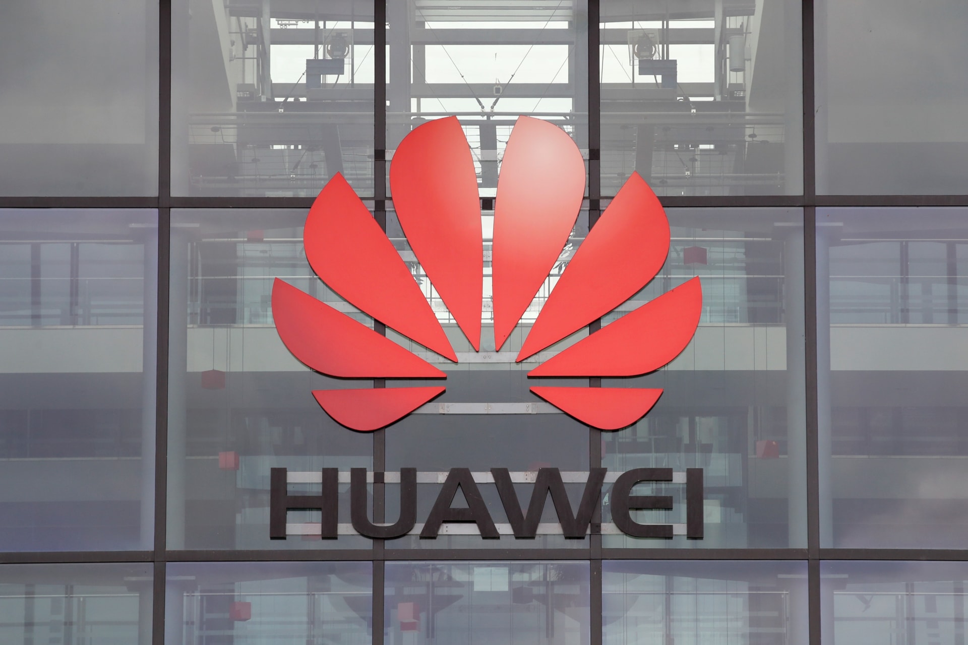 <p>Huawei logo is pictured on the headquarters building in Reading.</p>
