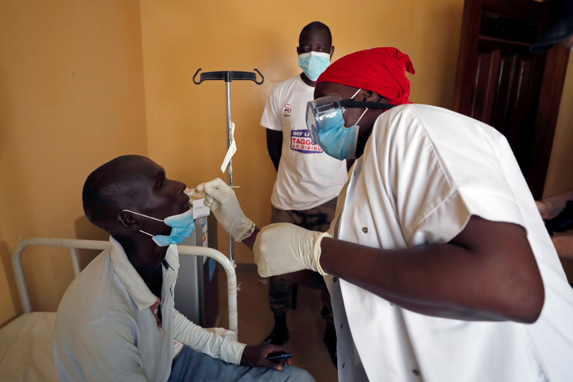 <p>A health worker takes a swab for a rapid antigen test as hundreds of thousands of Senegalese Mouride pilgrims gather for the annual Grand Magal festival, as the global spread of COVID-19 continues, in the holy city of Touba, Senegal on October 5, 2020.</p>
