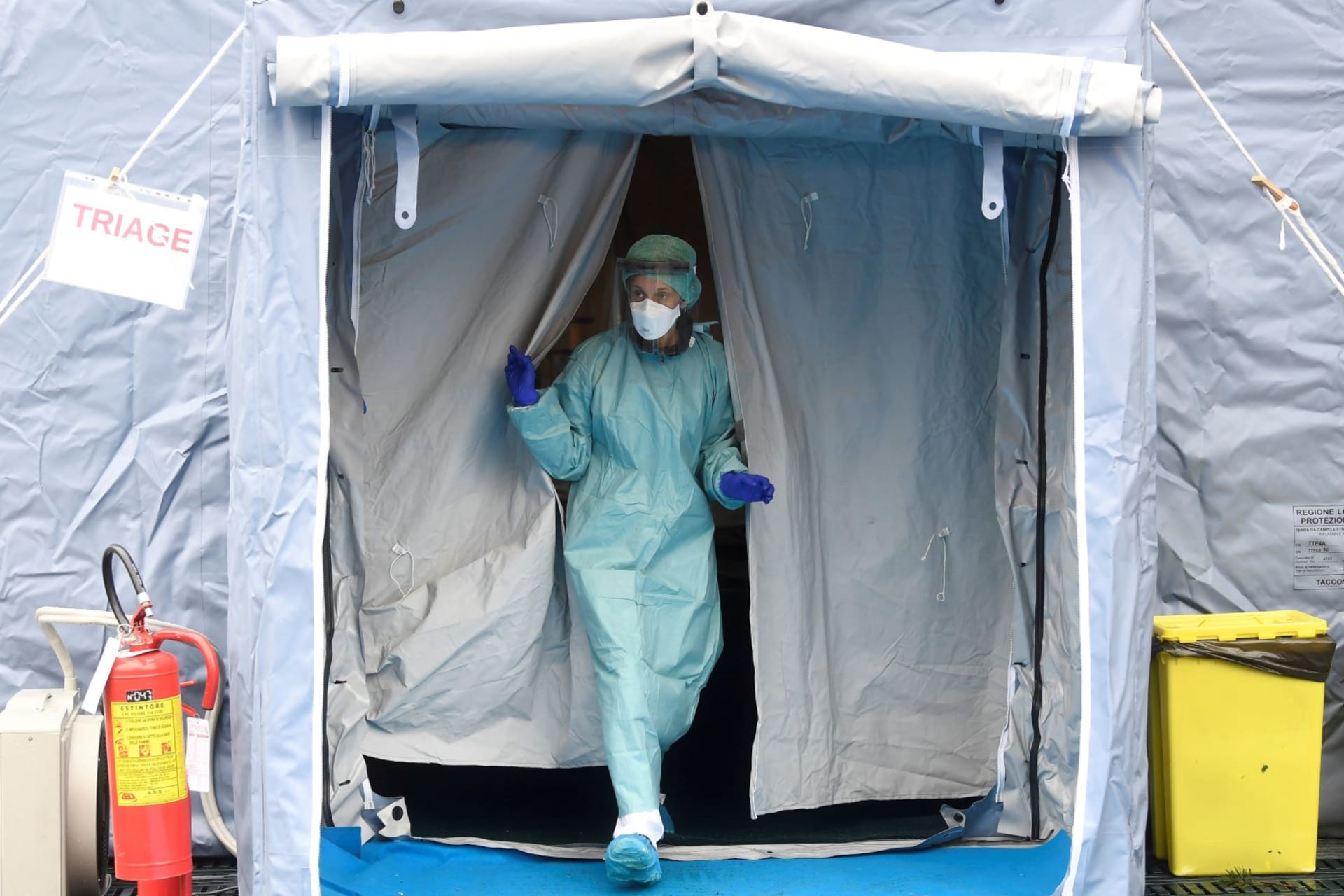 <p>A medical worker wearing protective mask is seen at a medical checkpoint at the entrance of the Spedali Civili hospital in Brescia, Italy on March 3, 2020. </p>
