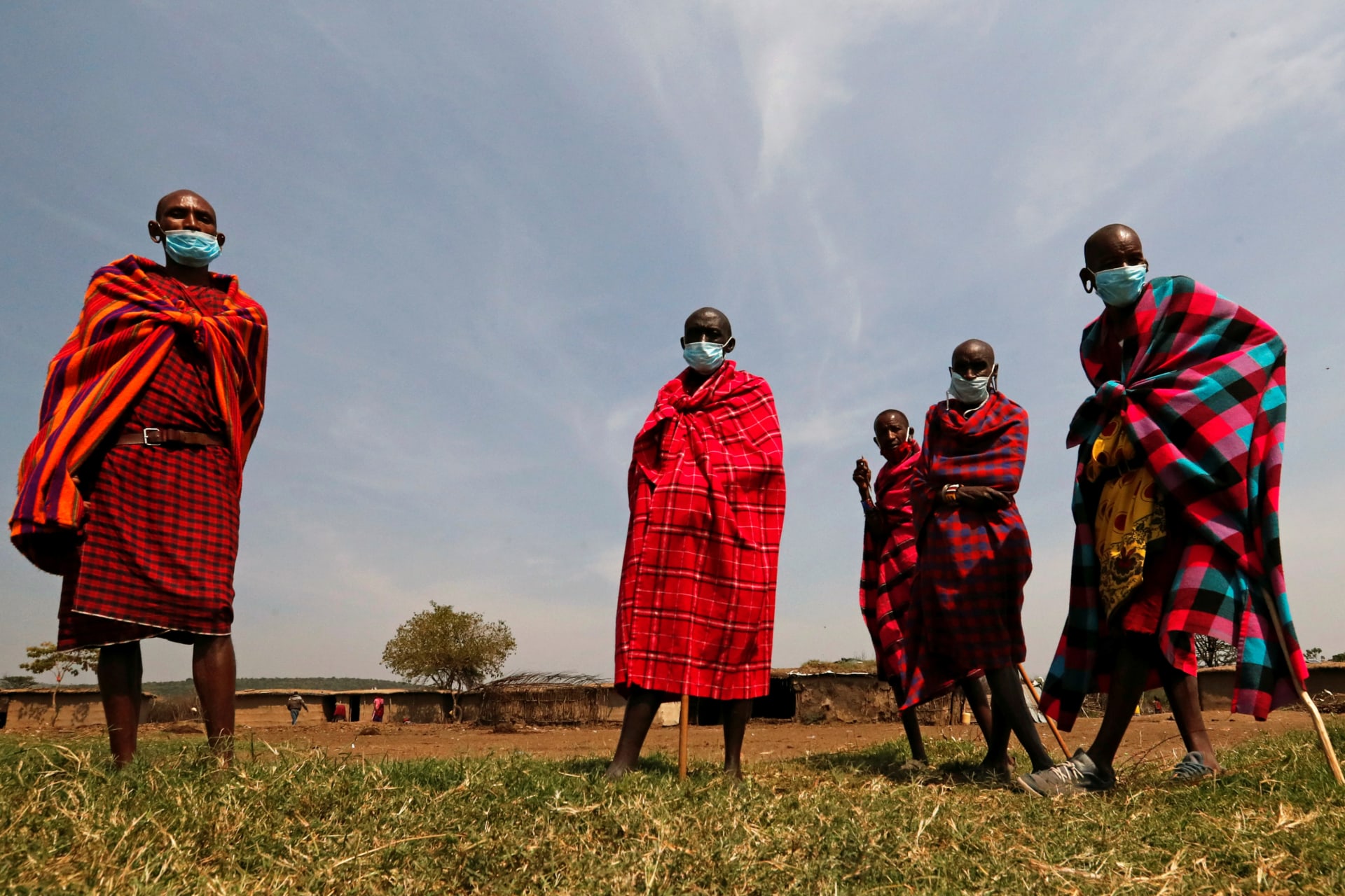 <p>Maasai elders, wearing traditional costumes with face masks on, gather at their homestead within the Orboma Manyatta in Sekenani, near the Maasai Mara game reserve in Narok County, Kenya, on August 10, 2020.</p>
