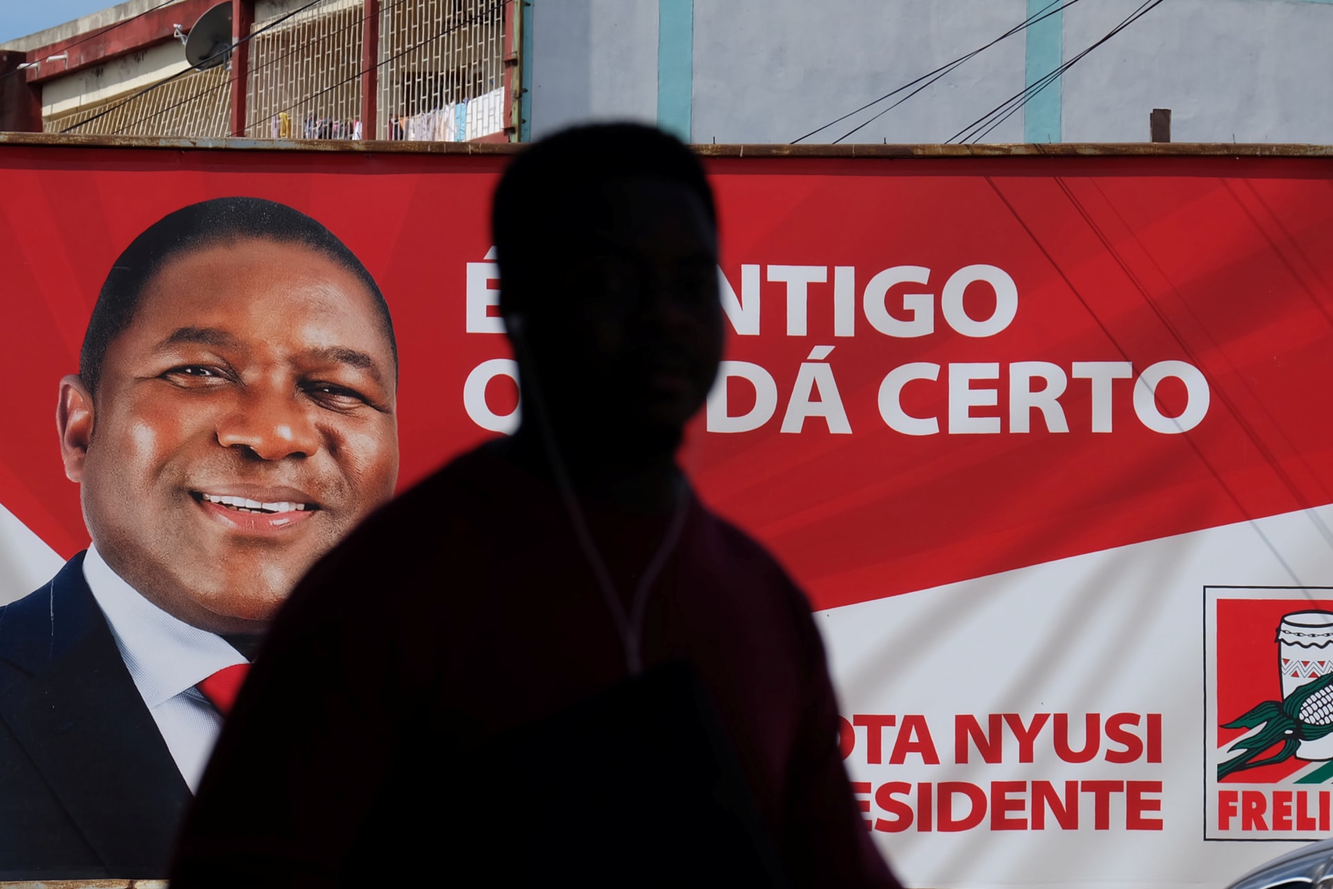 <p>A local walks past a billboard with a picture of Mozambique’s president and leader of the Frelimo Party, Filipe Nyusi, in Maputo, Mozambique, October 11, 2019</p>
