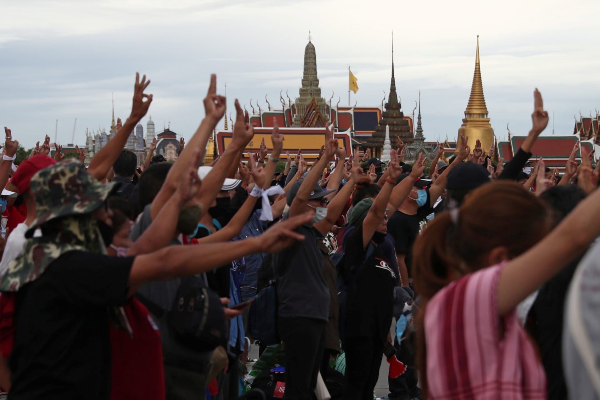 <p>Pro-democracy protesters display the three-fingered salute while singing the national anthem during a mass rally to call for the ouster of Prime Minister Prayuth Chan-ocha’s government and reforms in the monarchy, in Bangkok on September 20, 2020.</p>
