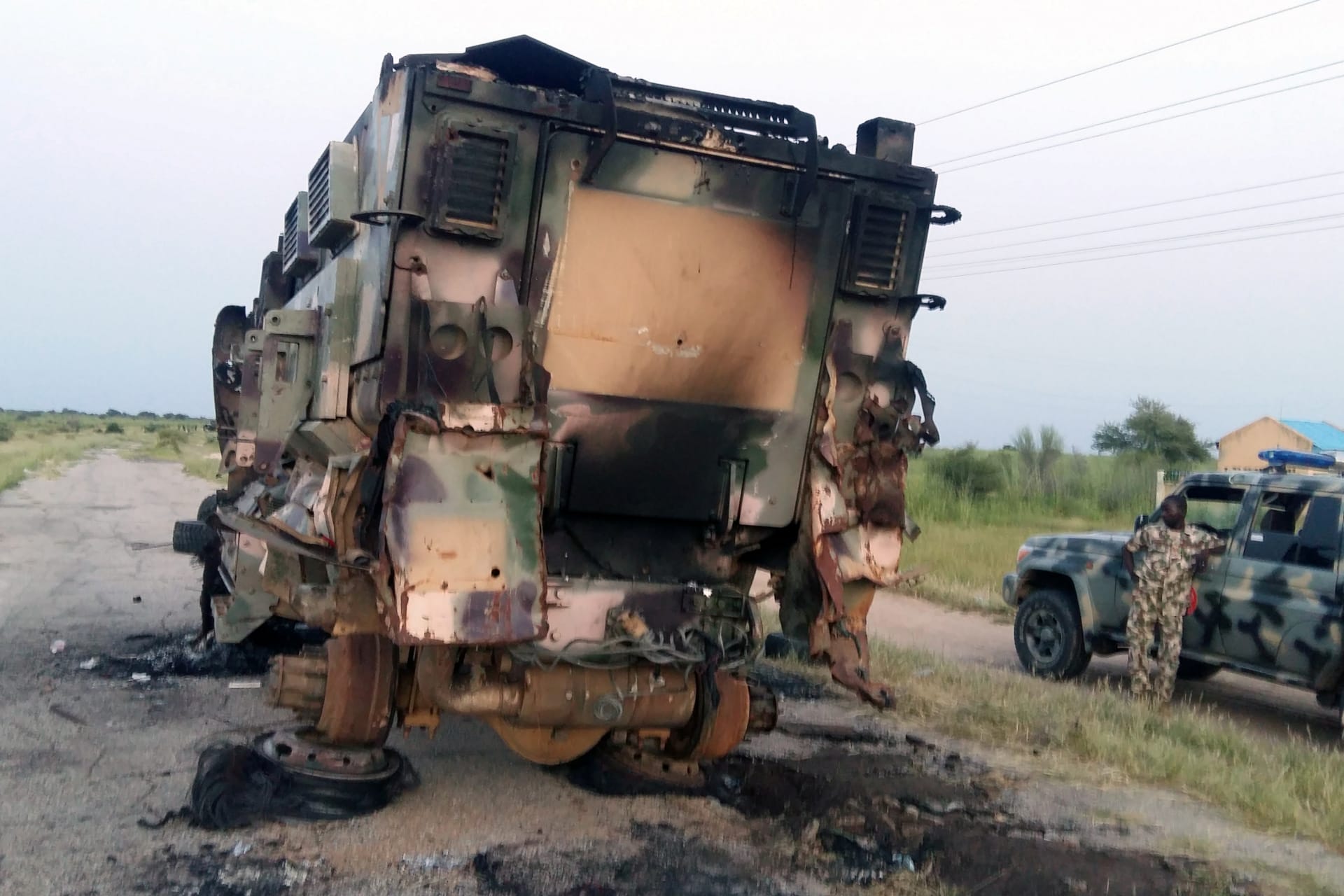 <p>A damaged military vehicle is pictured in the northeast town of Gudumbali, after an attack by members of Islamic State in West Africa (ISWA), on September 11, 2018.</p>
