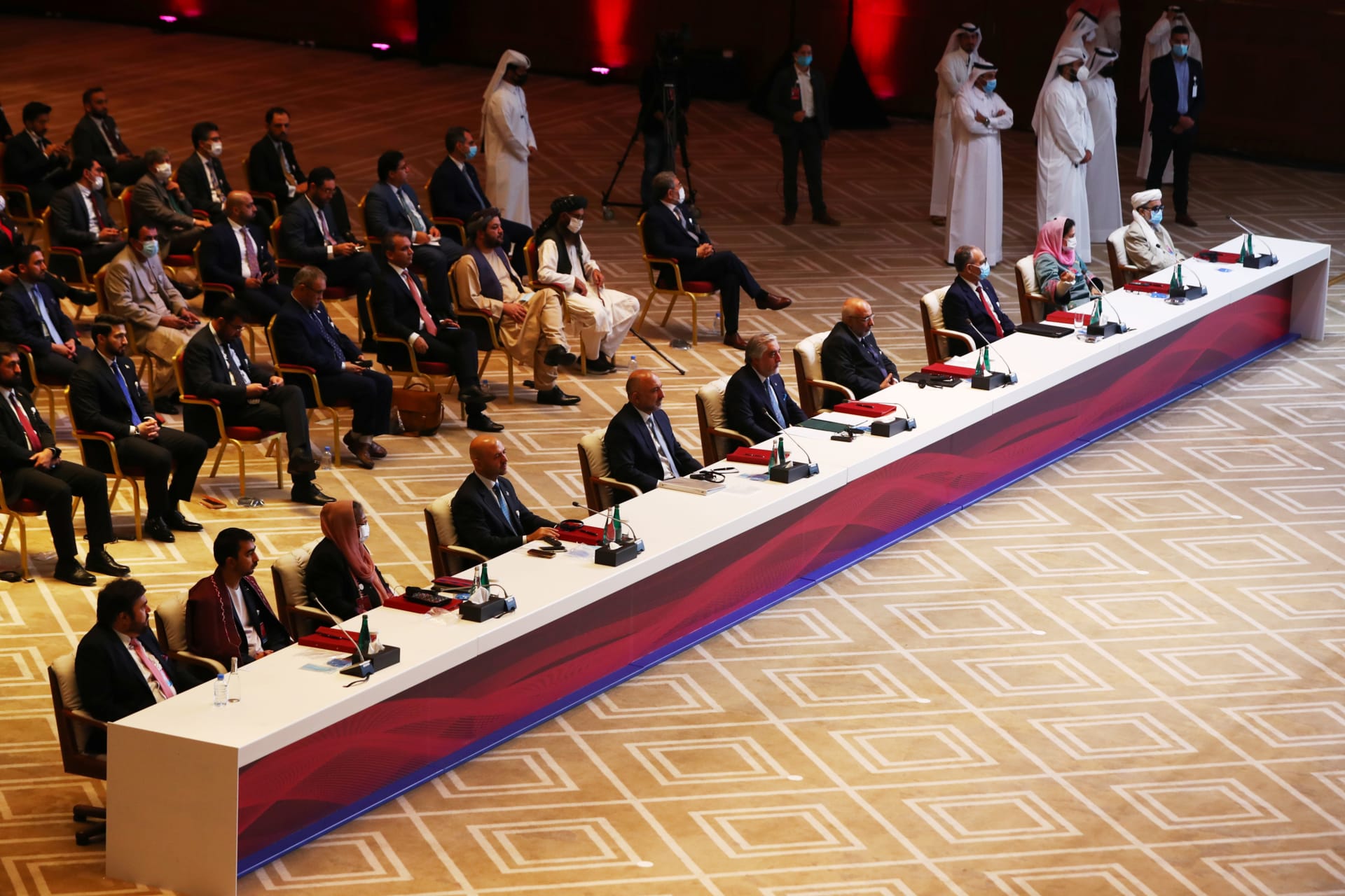 <p>Delegates are seen before talks begin between the Afghan government and the Taliban in Doha, Qatar, on September 12, 2020. </p>
