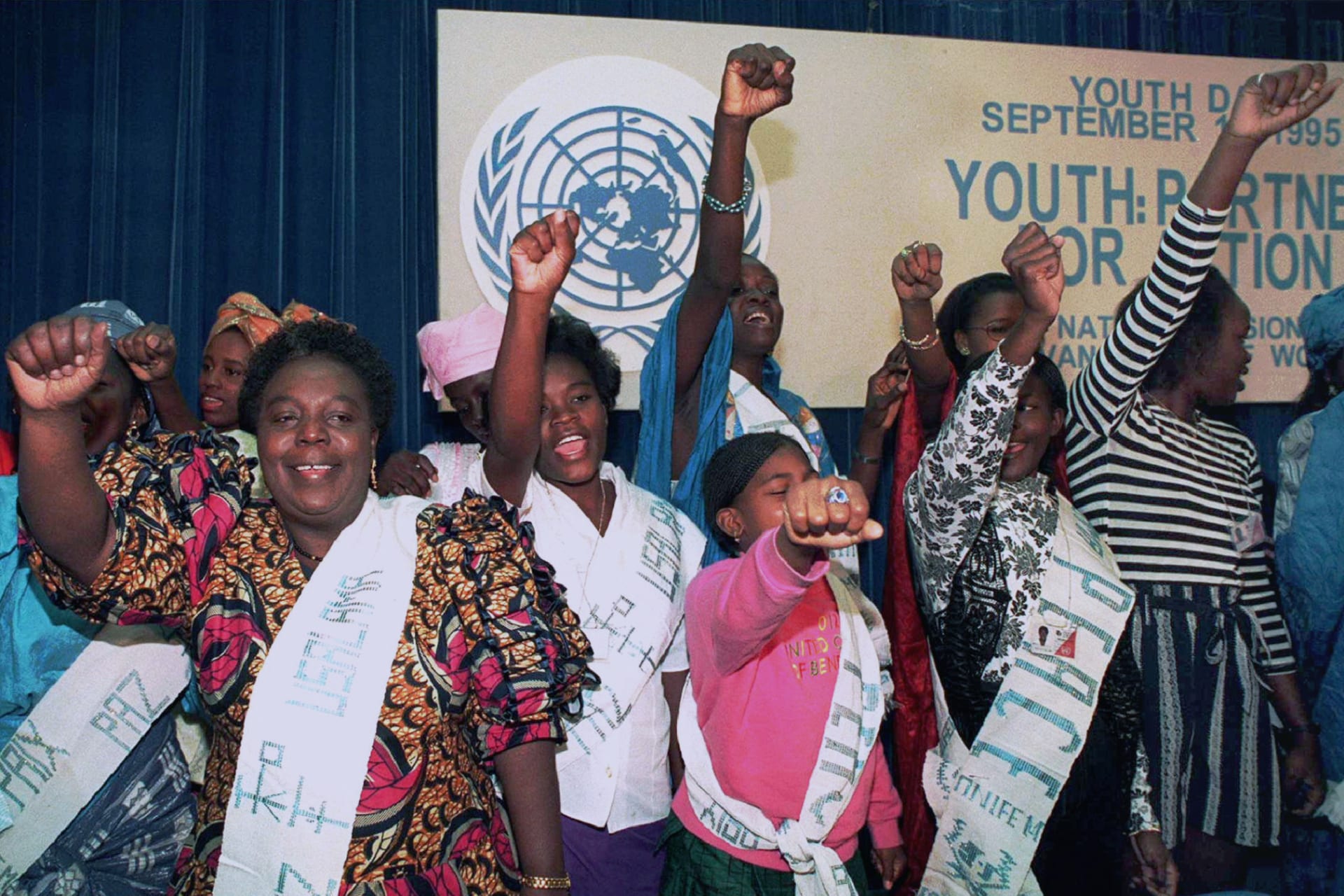 <p>Gertrude Mongella (L), then-secretary-general of the UN fourth world conference on women, sings along with an African women’s youth group. Beijing, China. September 11, 1995.</p>
