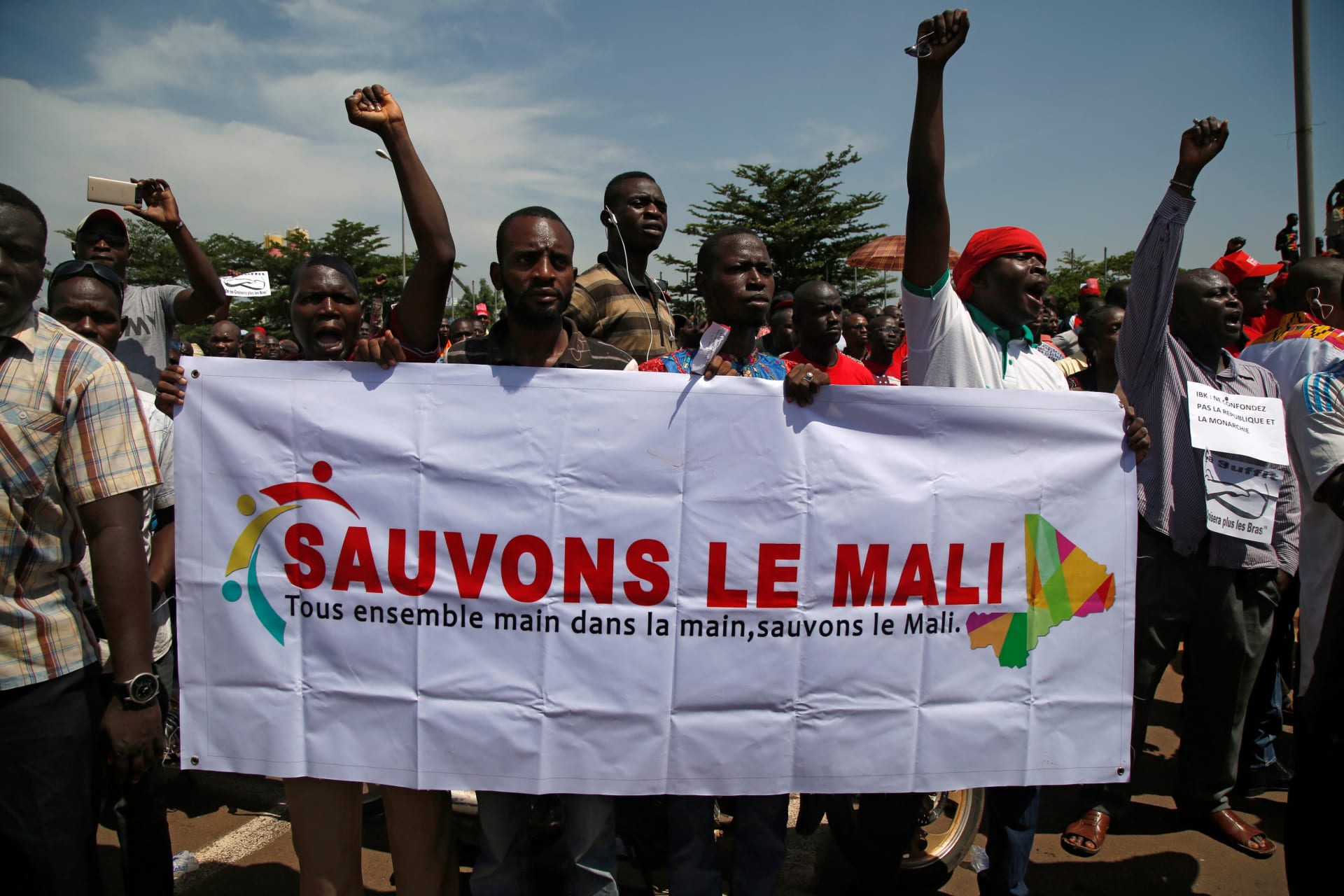 <p>Supporters of the Malian opposition hold a banner as they gather for a meeting to protest against plans to revise the constitution, in Bamako, Mali on July 1, 2017. The banner reads “Let’s save Mali, all together hand in hand, let’s save Mali.”</p>
