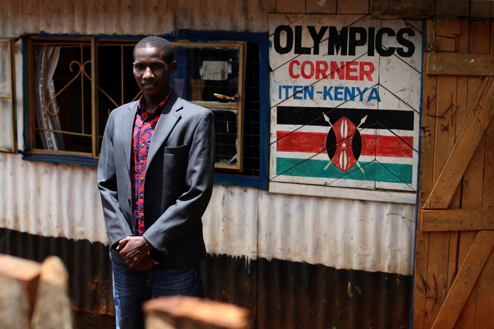 <p>Kenyan runner Johana Kariankei, 24, poses by his shop which sells athletic souvenirs in Iten, western Kenya, on April 11, 2016.</p>
