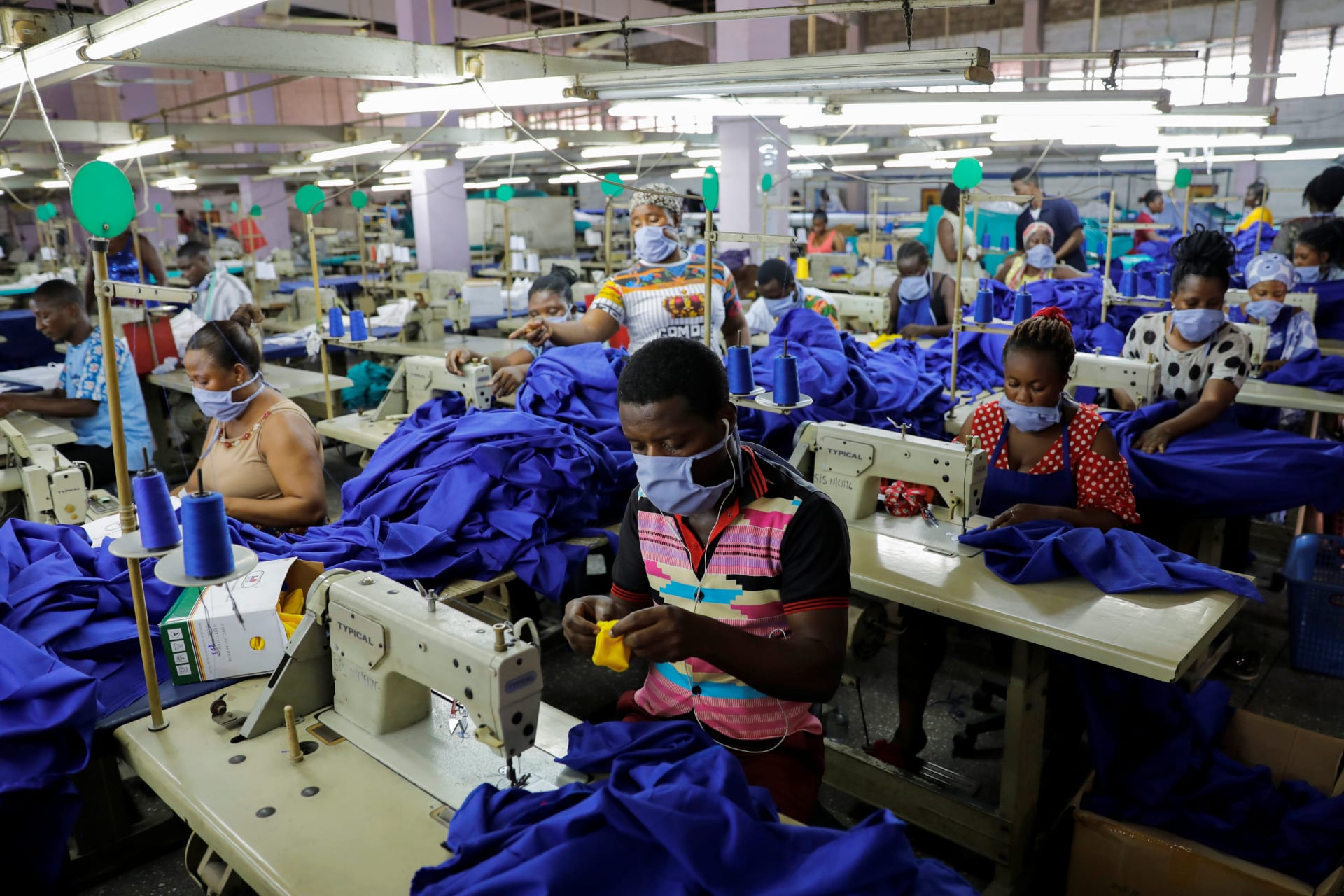 <p>Workers of a local factory begin the production of personal protective gear for local frontline health workers as commissioned by the government, during the partial lockdown in Accra to slow the spread of the COVID-19, in Accra, Ghana. April 10, 2020</p>
